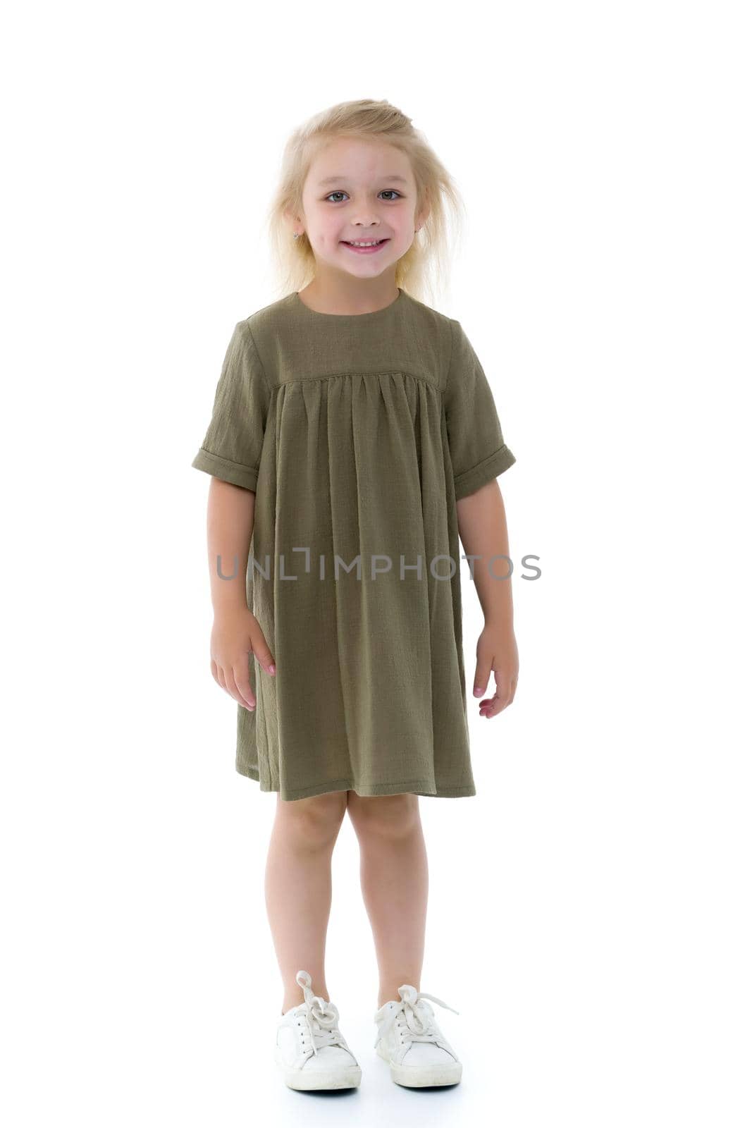 Charming little girl in a light summer dress. Concept of family vacation, happy childhood. In isolation.