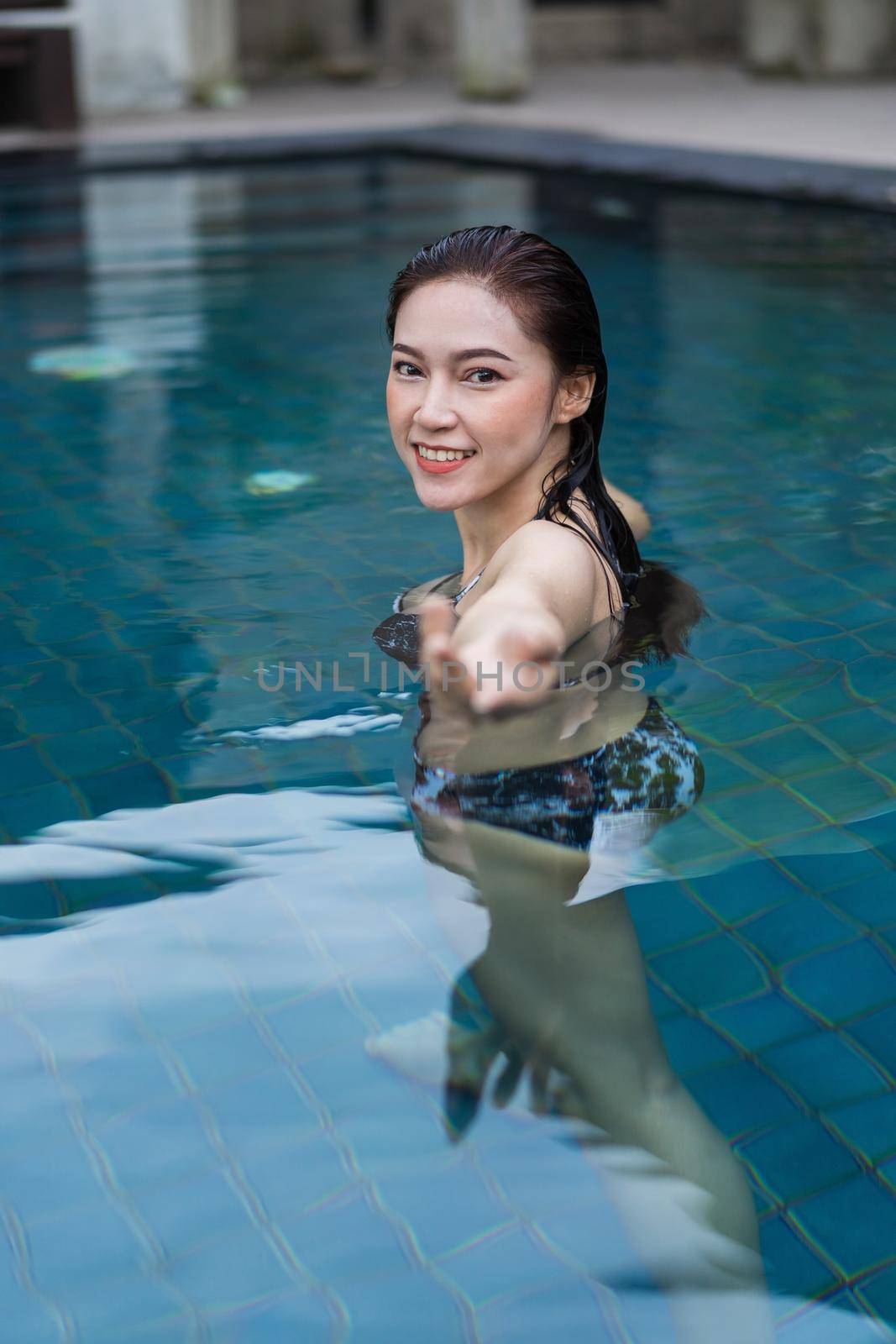 happy beautiful woman in the swimming pool 