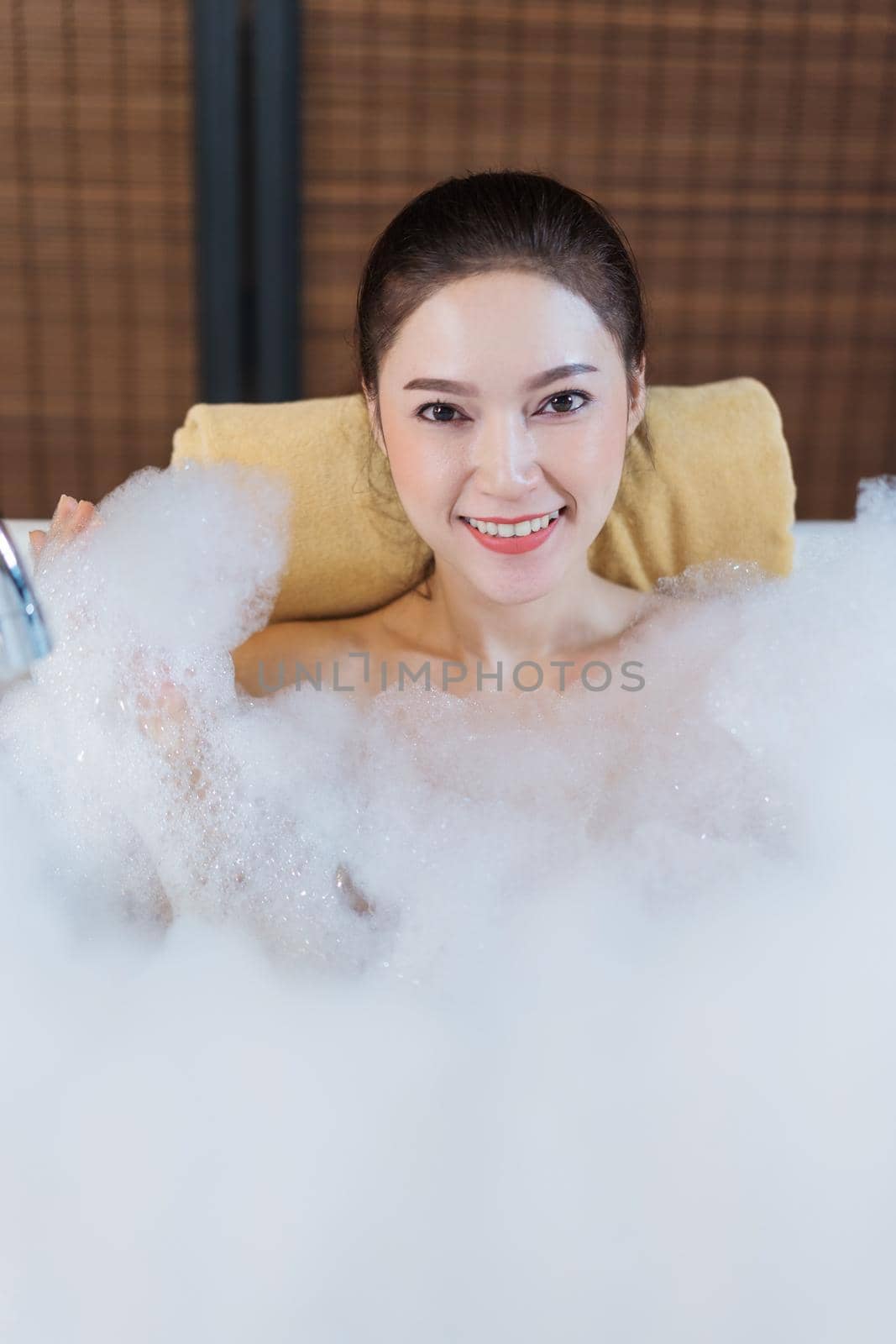 woman takes bubble bath and playing in bathtub by geargodz