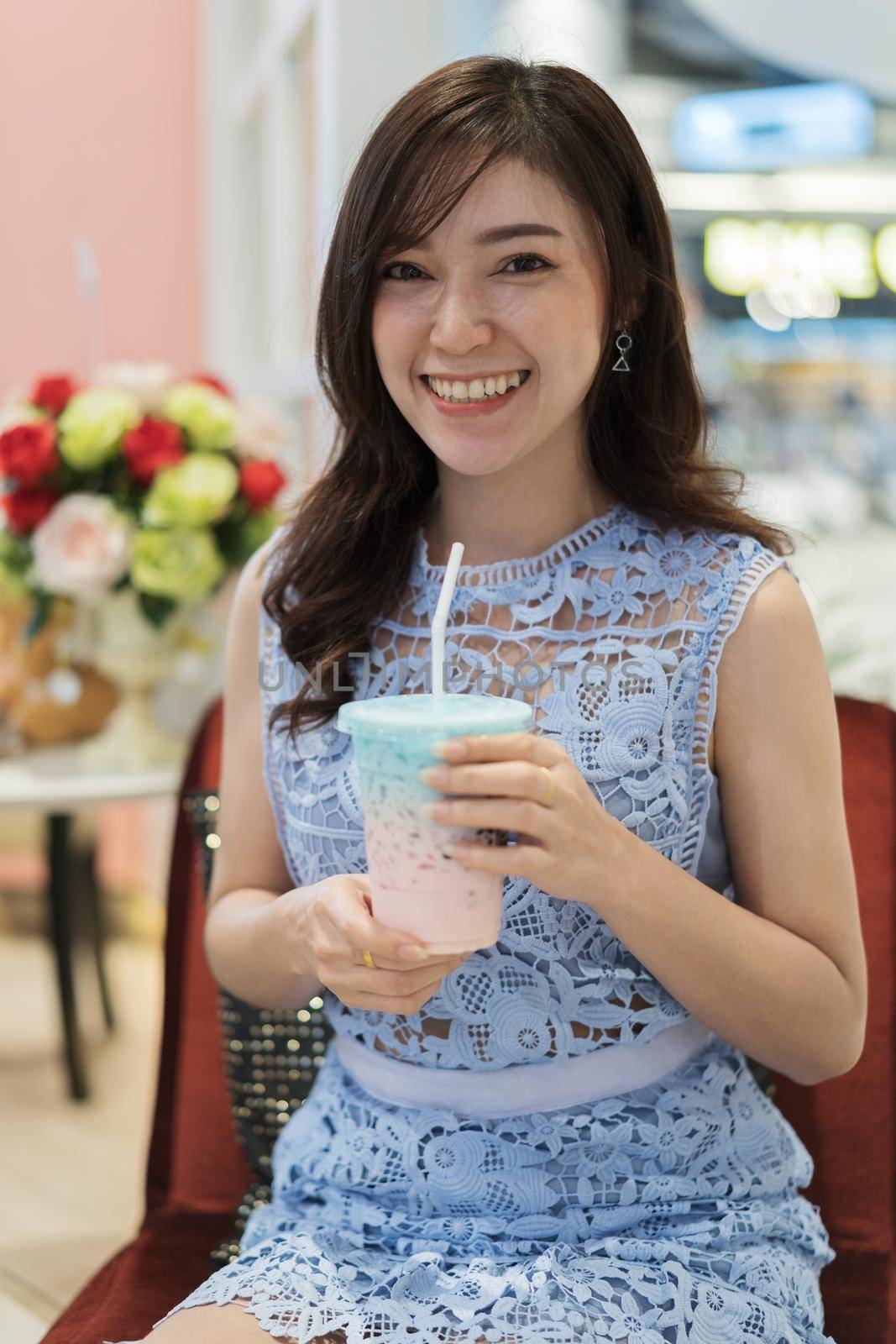 woman drinking a cup of milk at a cafe