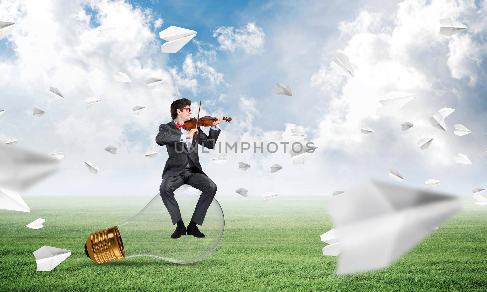 young businessman plays the violin, the concept of creativity in business