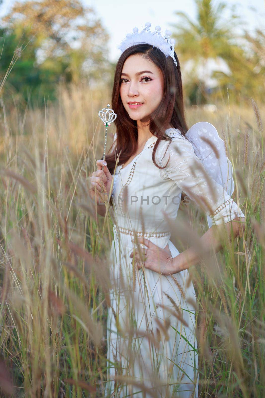 angel woman in a grass field with sunlight by geargodz