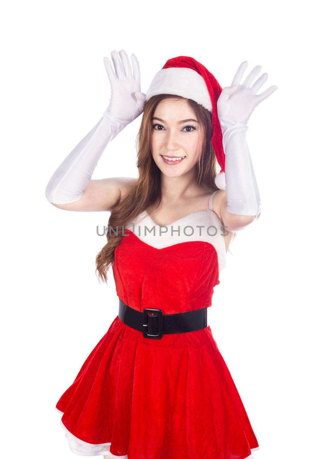 beautiful sexy woman wearing santa claus clothes acting like a reindeer making ears with hands isolated on white background.