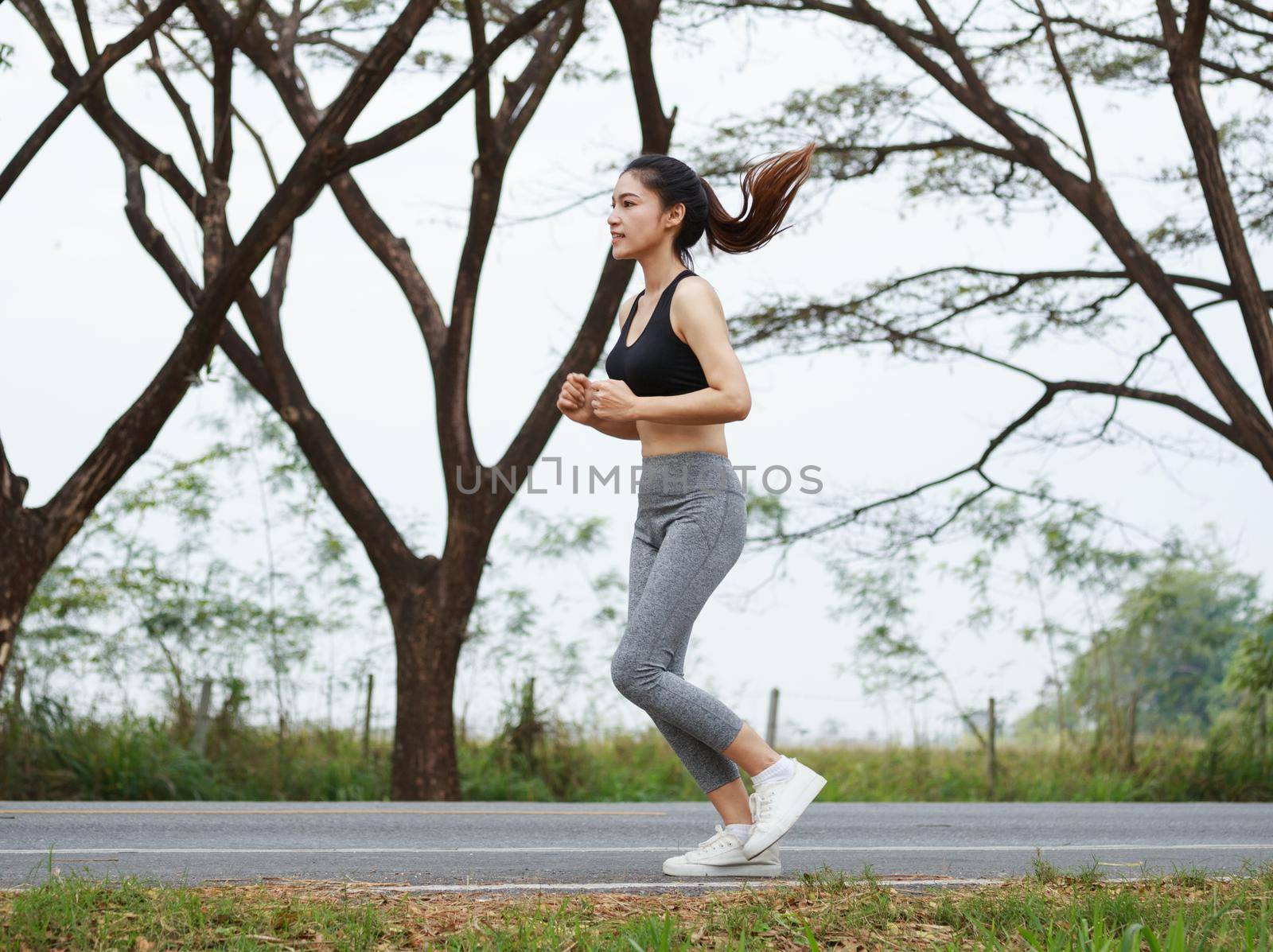 beautiful fitness woman running in the park