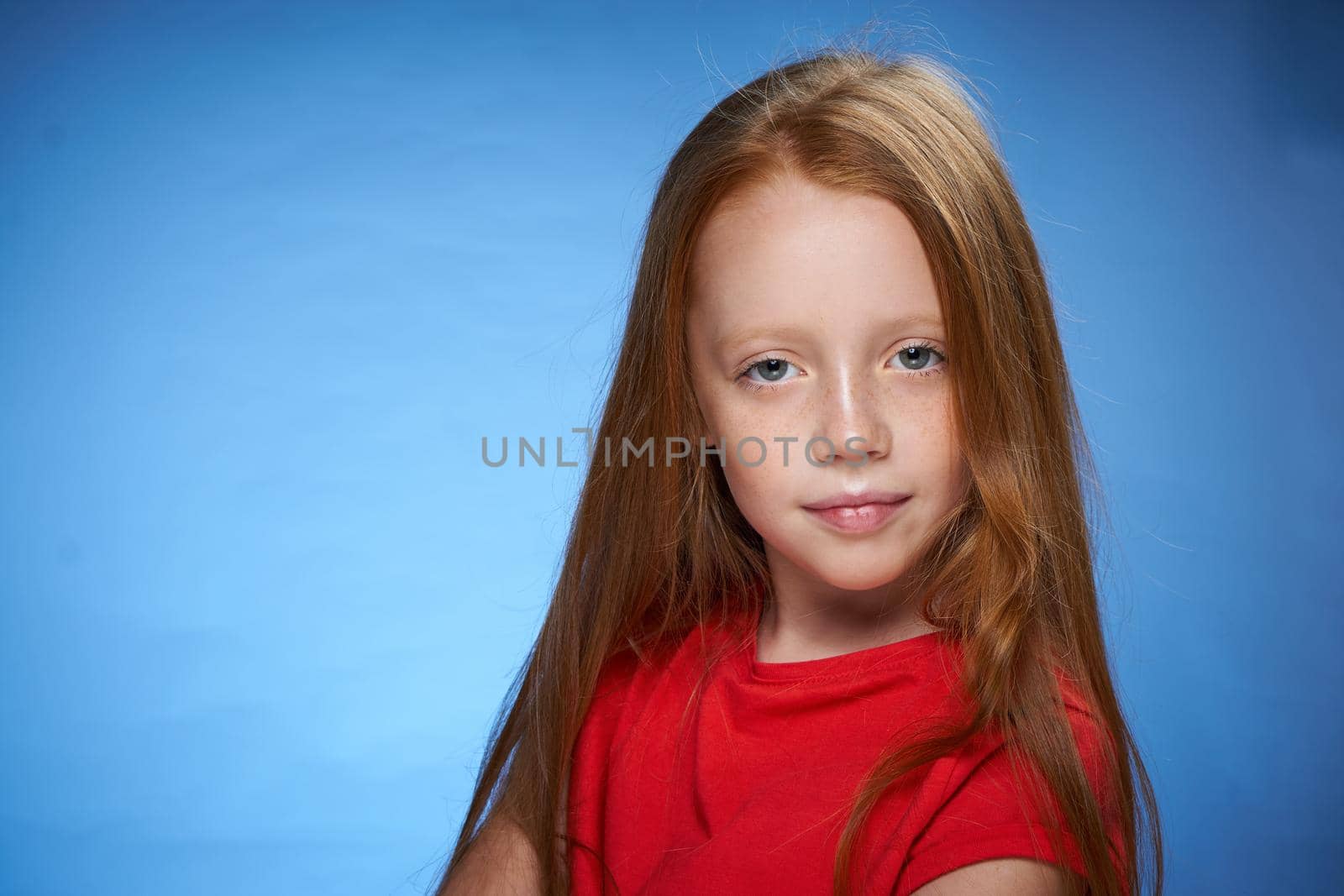 cute red-haired girl in red t-shirt emotions blue background by Vichizh