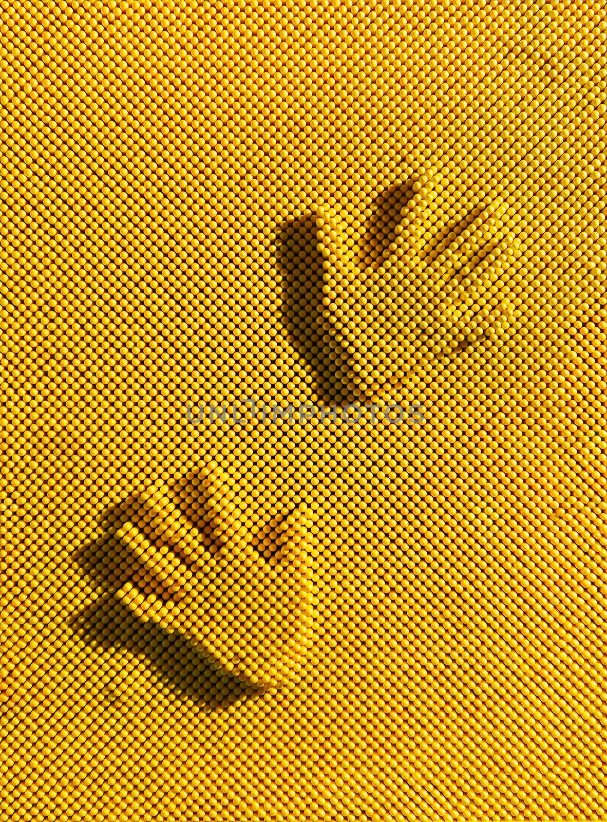 Two handprints on the yellow plastic pinscreen. Trace children's hands. Pinart