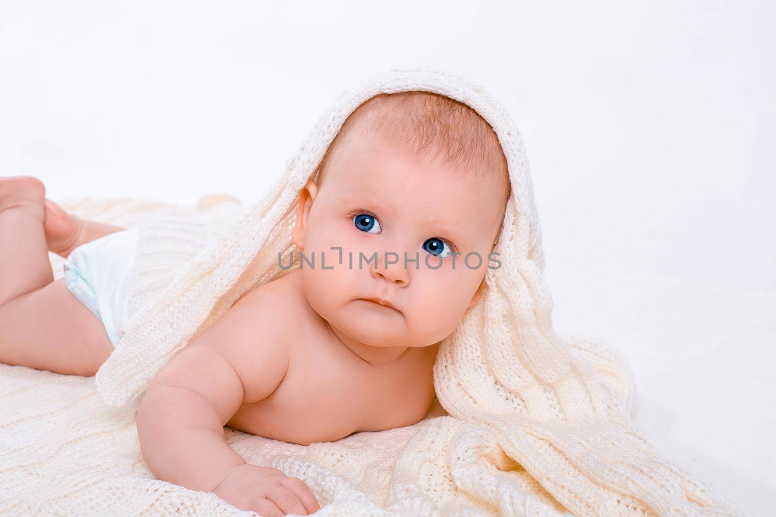 Cute baby girl on white background with isolation. Baby with a towel on his head