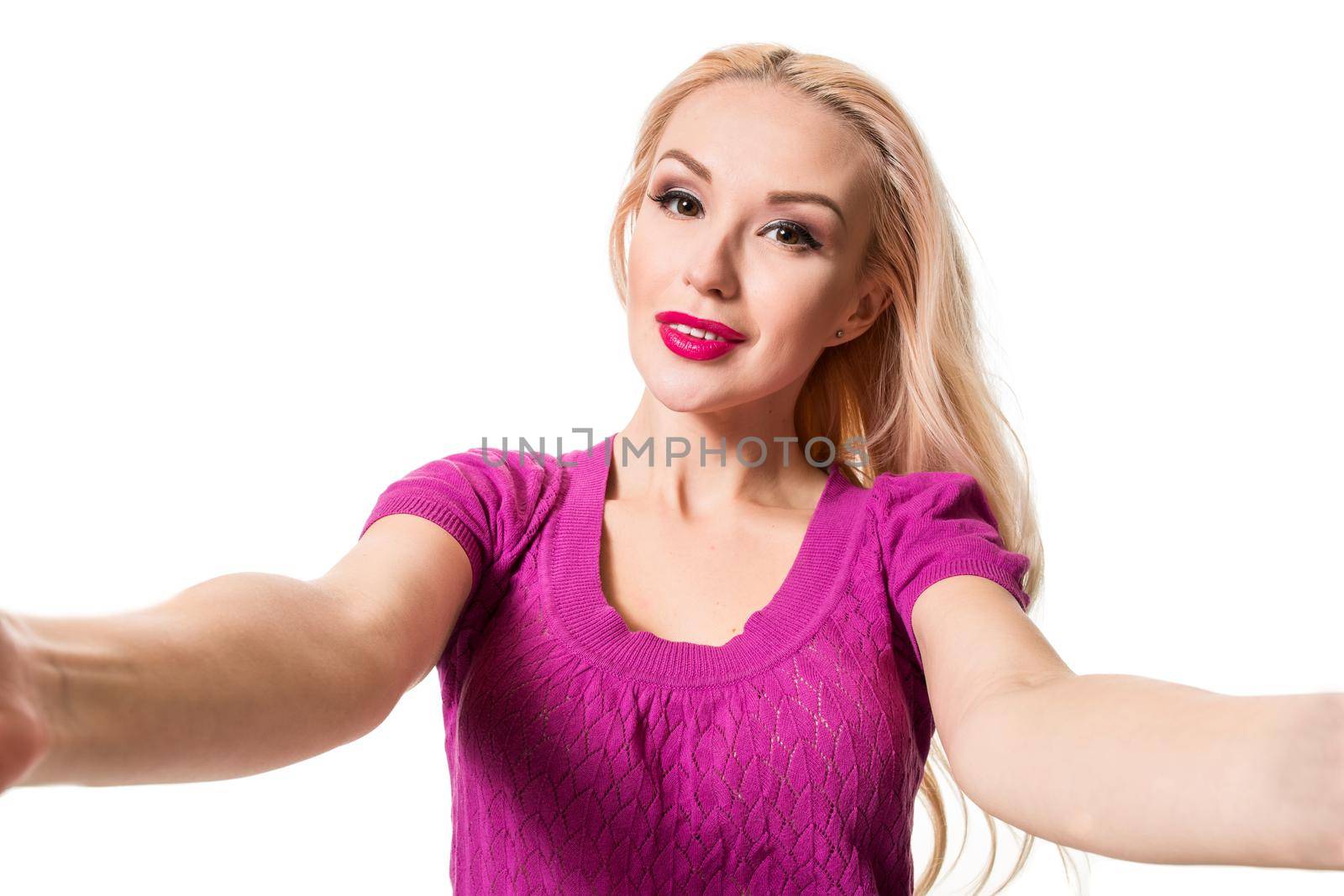 Smiling cheerful blond-haired woman doing selfie on isolated white background. Taking picture.