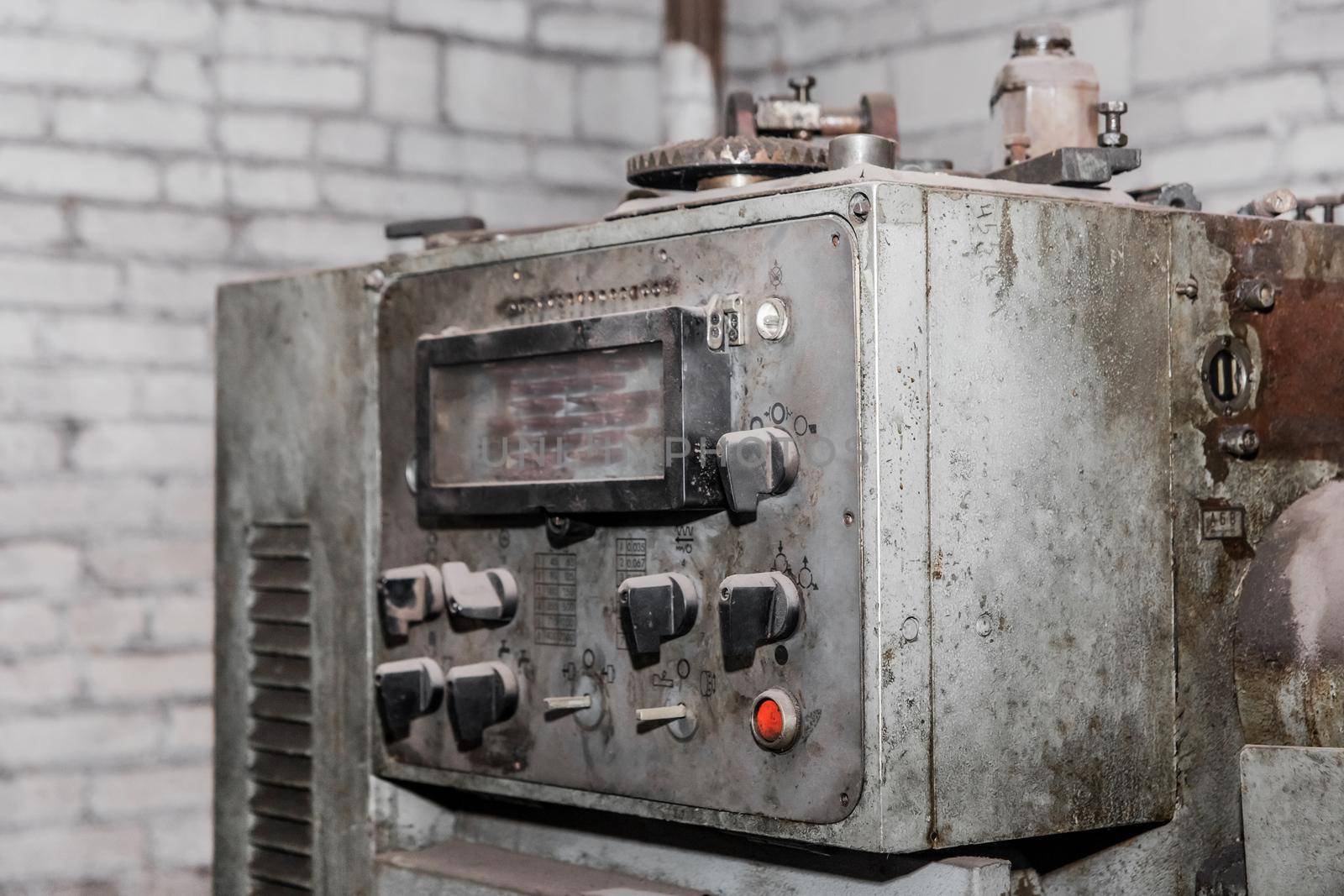 Old control panel of the turning turret of industrial equipment in the workshop at the plant by AYDO8