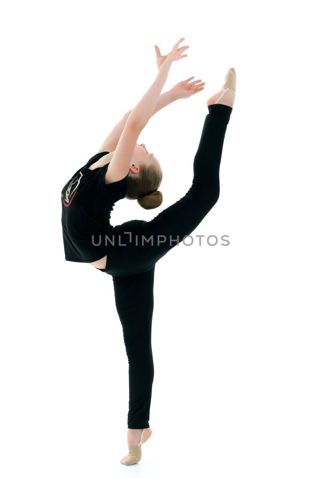 little girl gymnast performs an exercise. Balance on one leg with a grip. Sport concept, gymnastics, fitness. Isolated on white background.