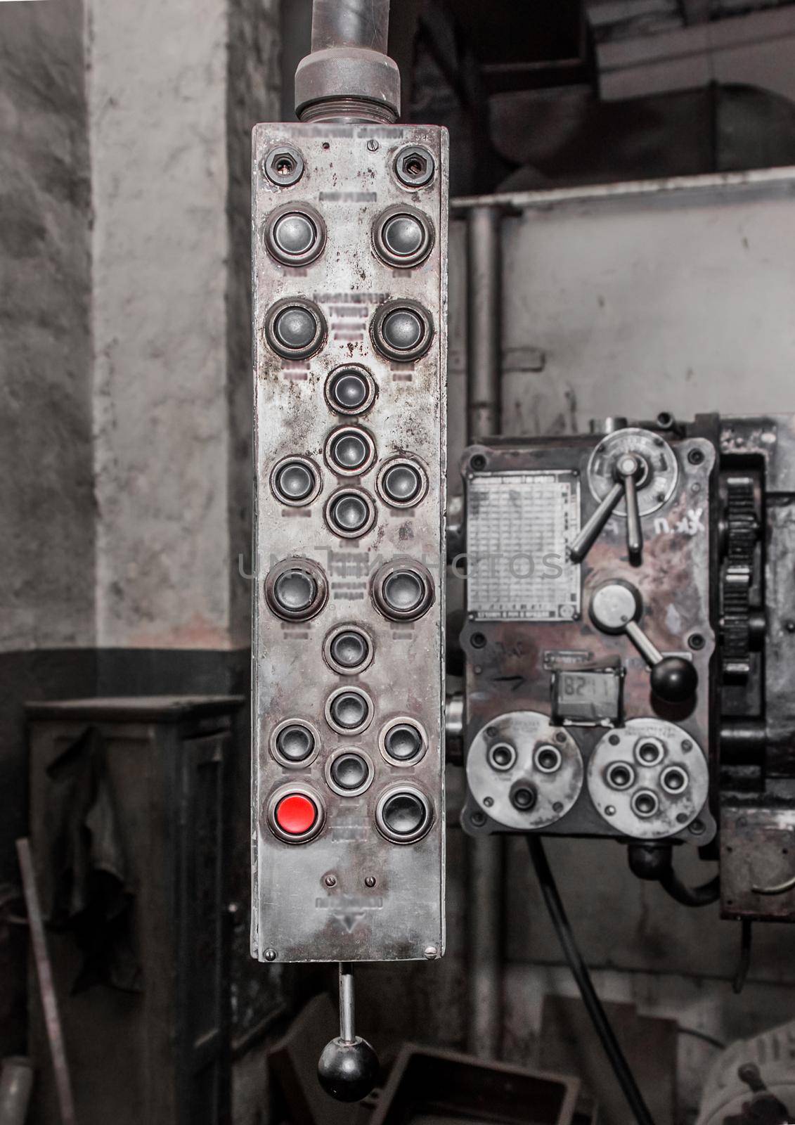 Old, dirty hanging vertical system and control panel with buttons for industrial equipment in the factory by AYDO8