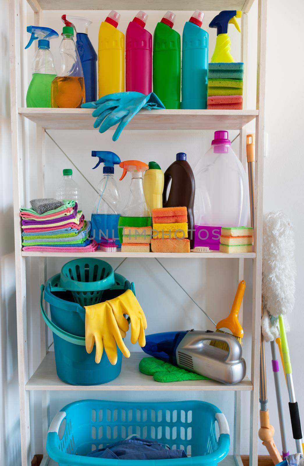 Shelves with cleaning products and tools in pantry