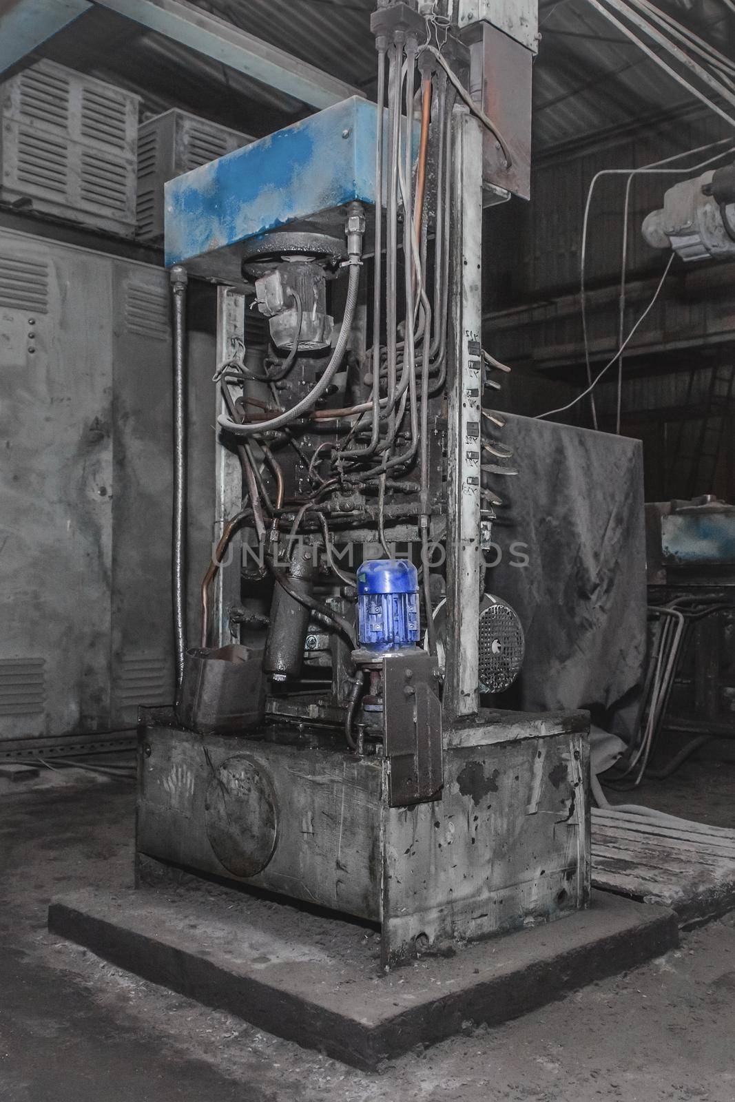 Old equipment or machine with tube and hose system and electric flange motor in the workshop of an industrial plant by AYDO8