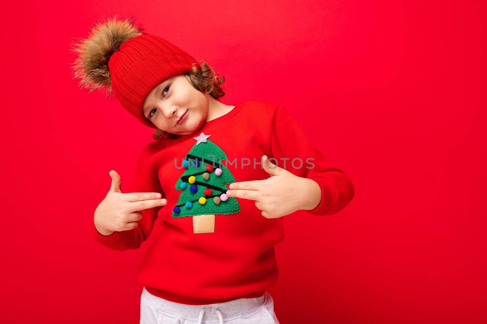 emotional portrait of a teenager on a red background in a new year costume.