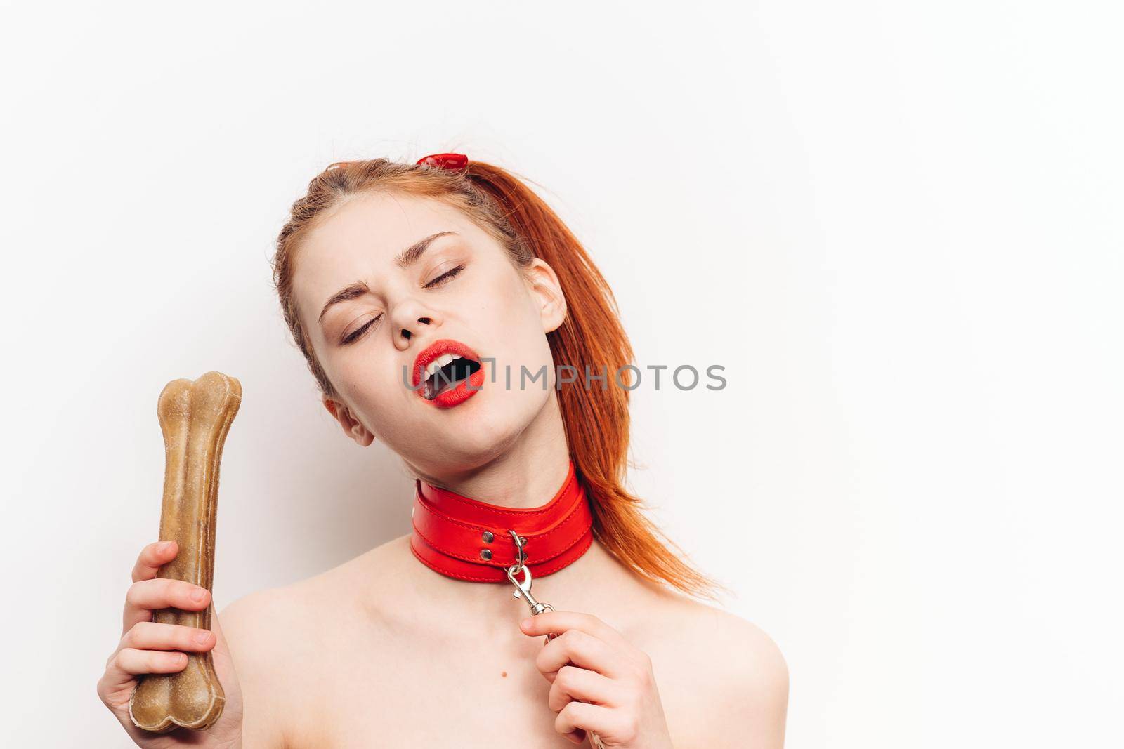 pretty woman with leash around her neck dog bone costume posing by Vichizh