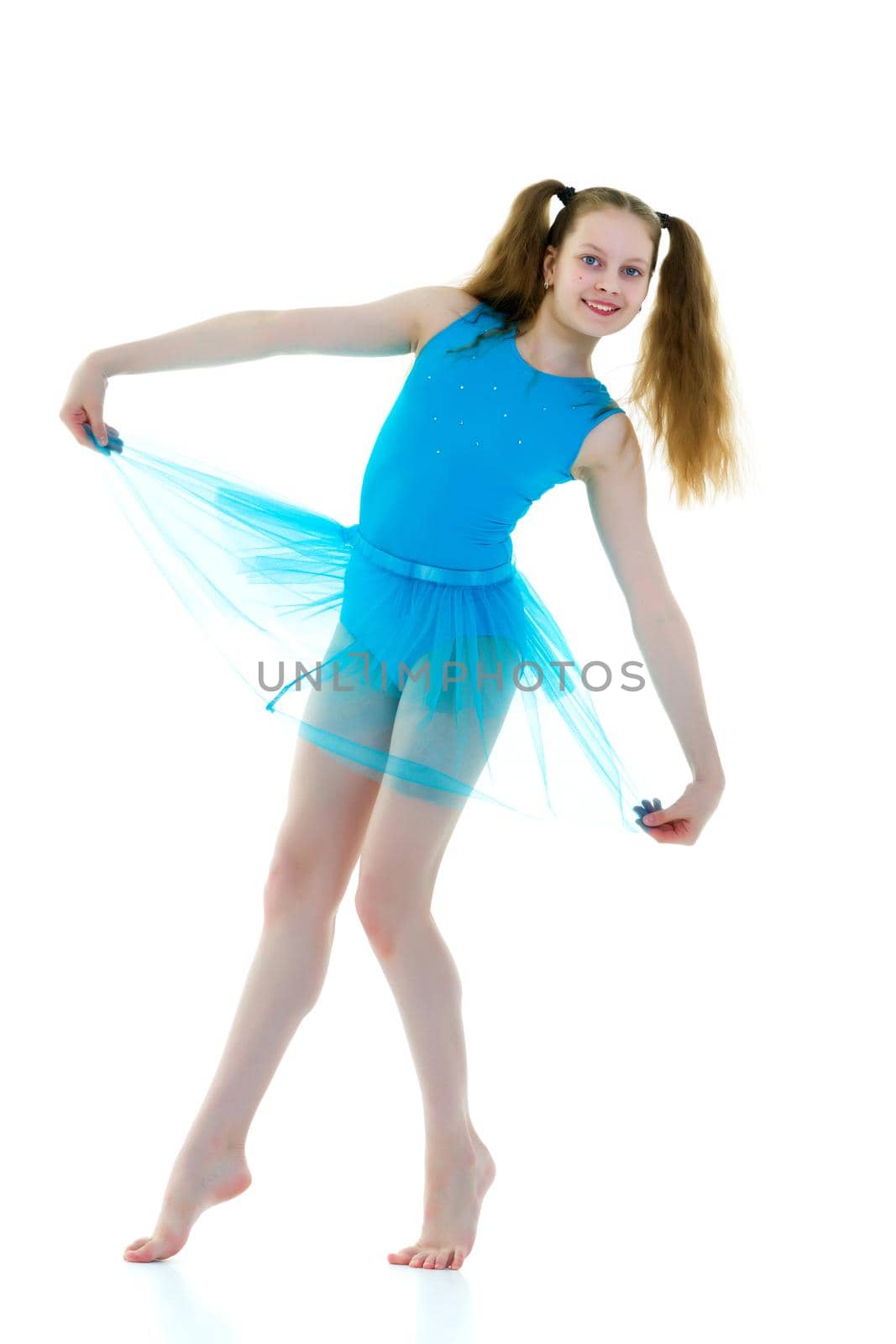 A gymnast girl prepares for the exercise. The concept of childhood and sport, a healthy lifestyle. Isolated on white background.