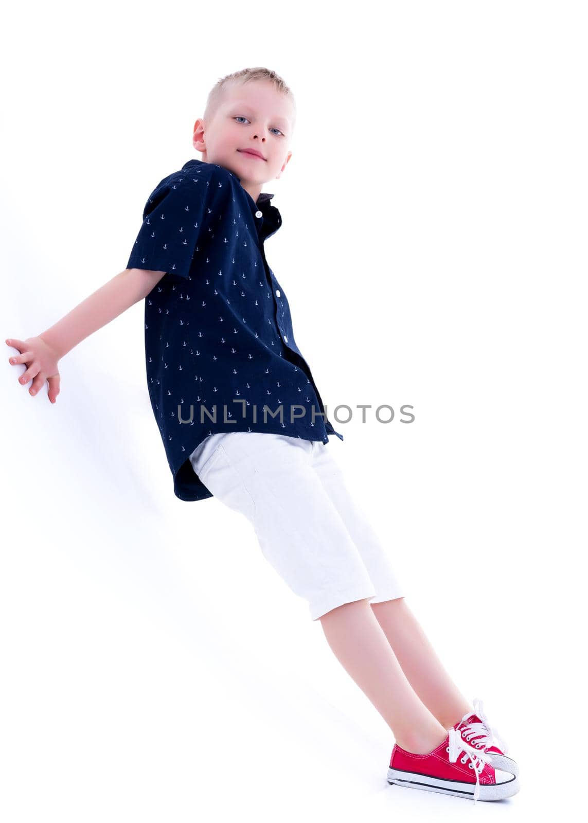 Cute little boy studio portrait on white cyclorama. The concept of a happy childhood. Isolated on white background