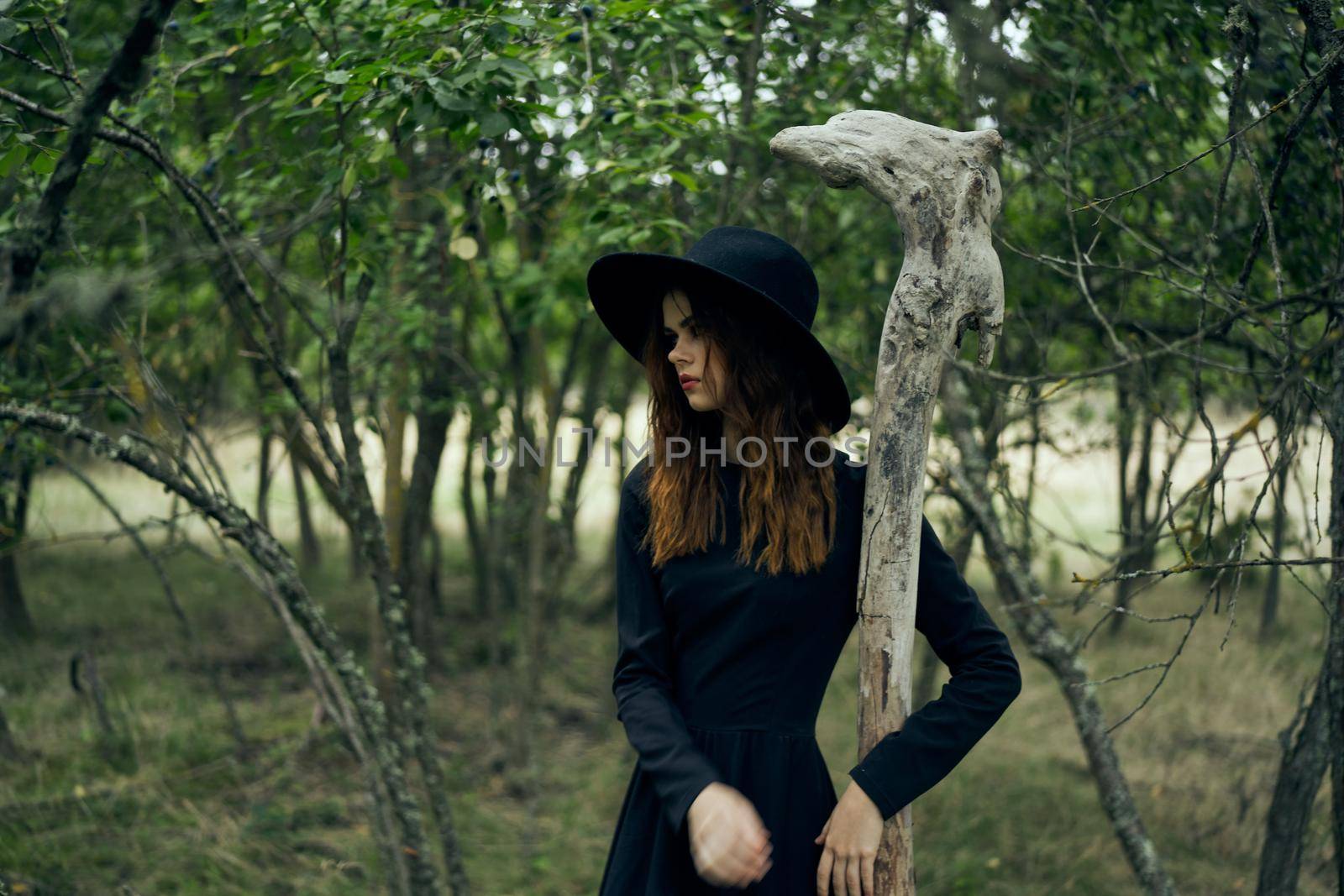 woman in witch costume in forest posing staff logic by Vichizh