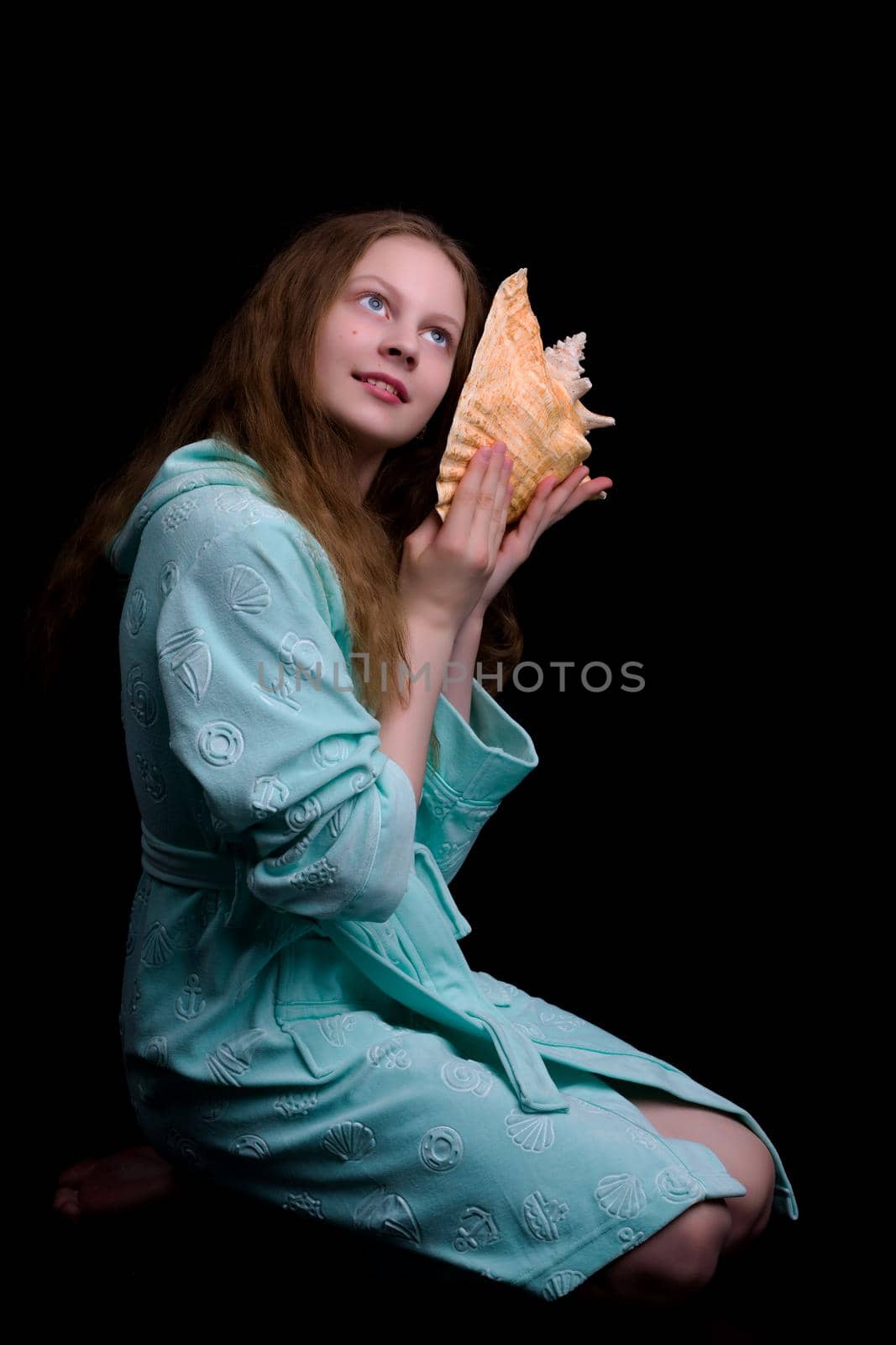 A little girl with a sea shell. The concept of a family vacation at sea, ecology. Isolated background.