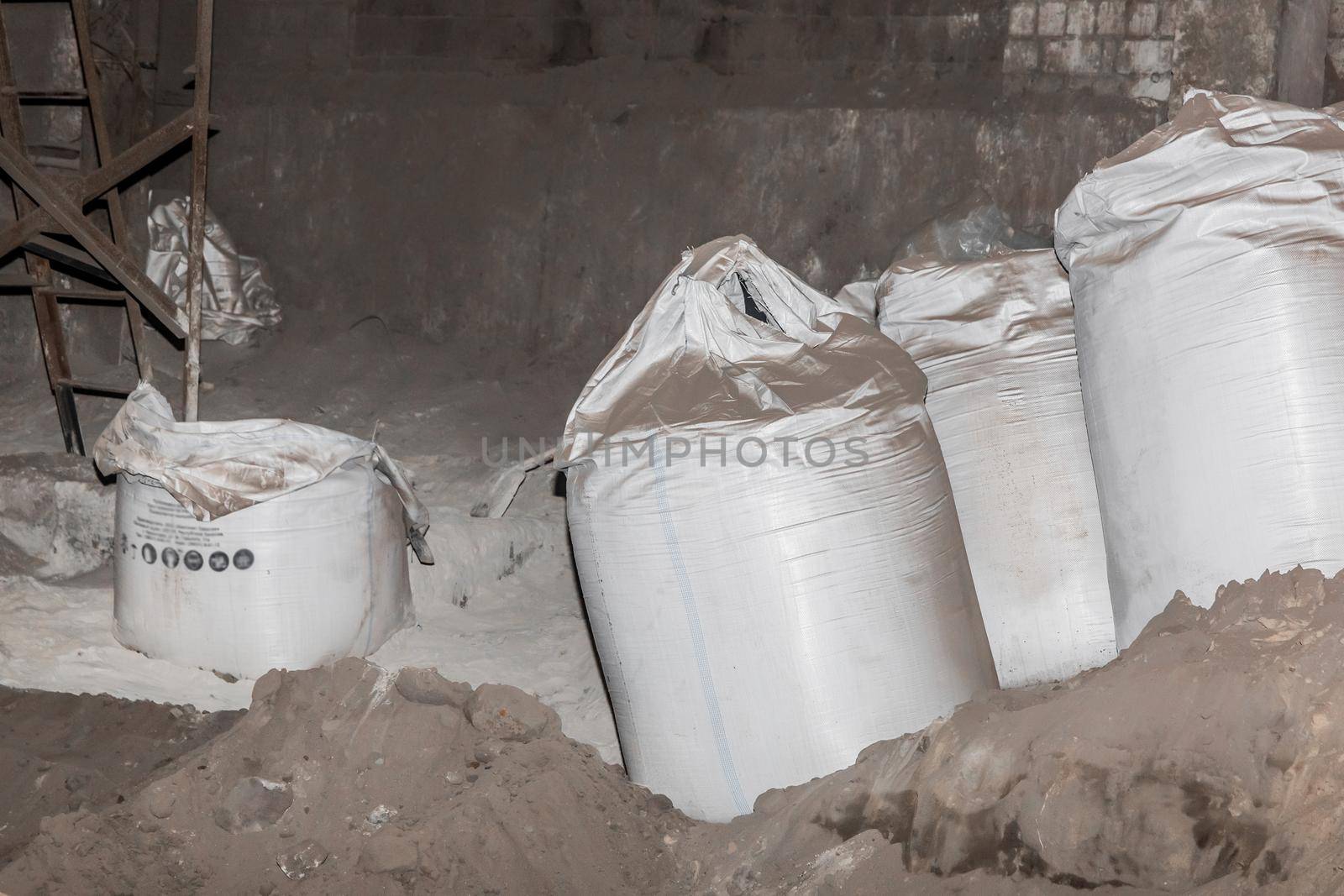Bentonite clay powder packed in bags at an industrial plant for processing sand, soil and land.
