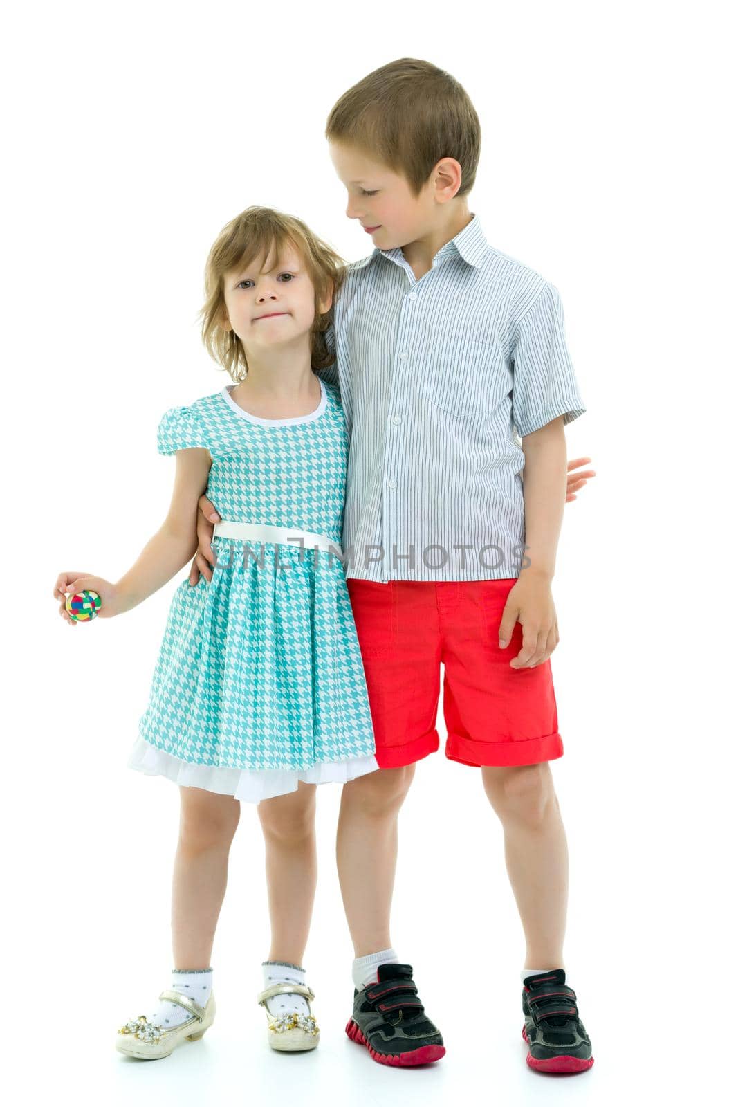 Boy and girl, brother and sister posing in the studio. Concept of family values, friendship, game. Isolated on white background