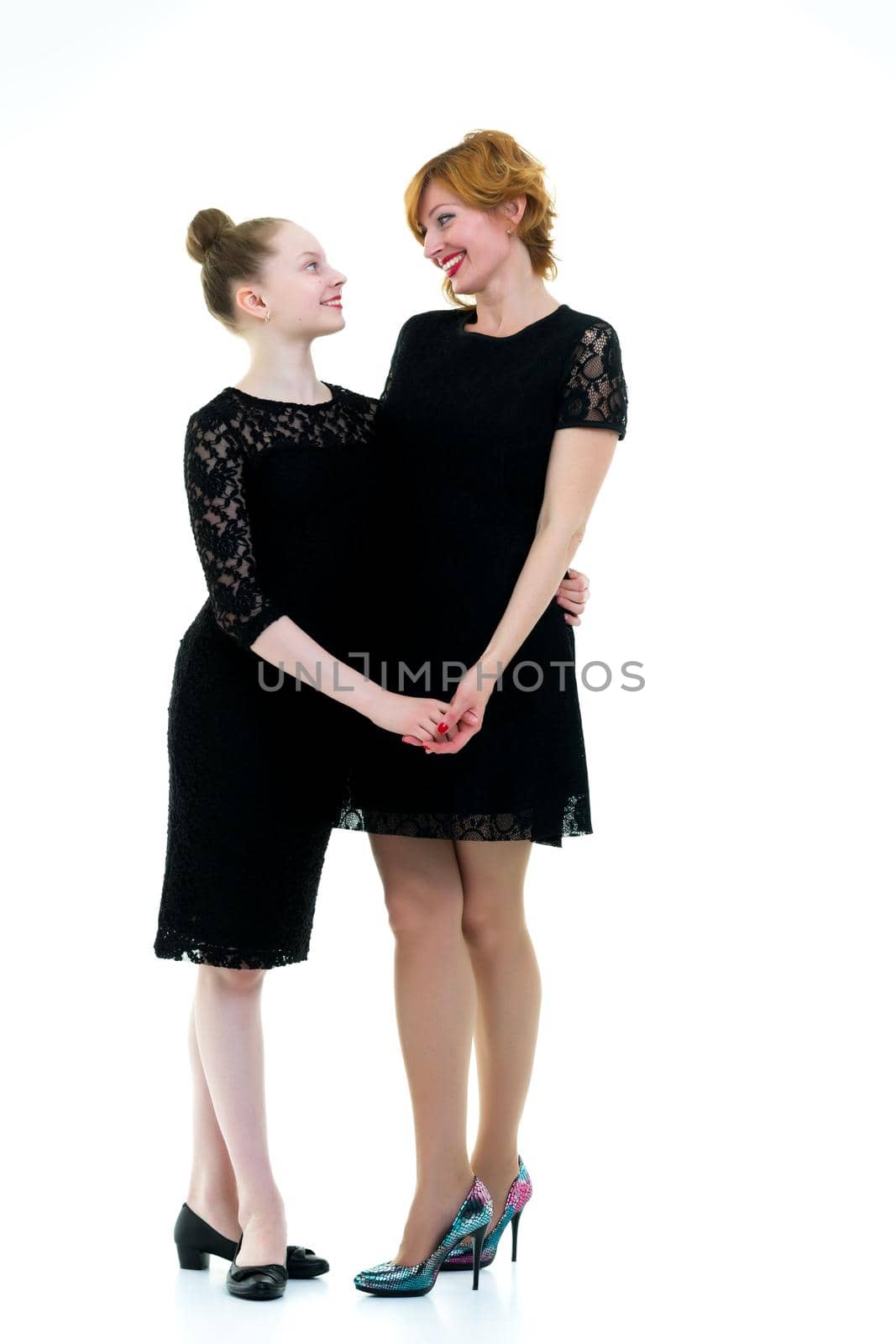 Happy family mom and little daughter hold hands. Isolated on white background.