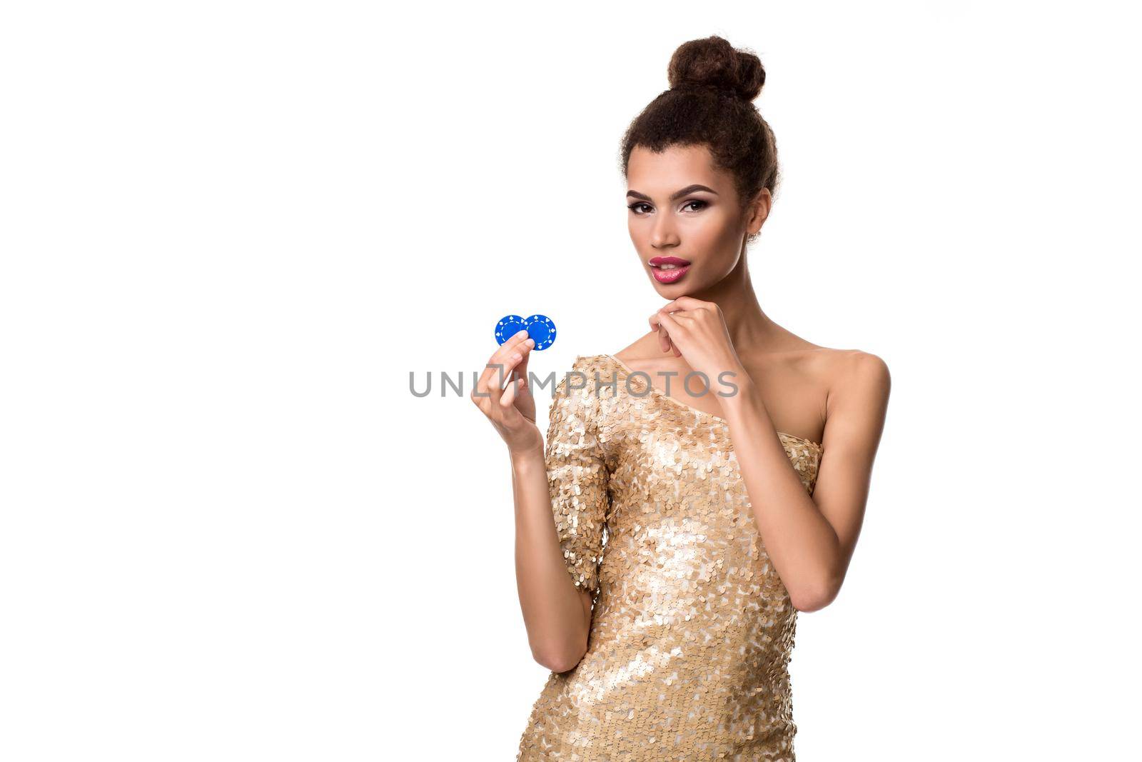 Smiling young woman holding two chips in her hands. Woman in gold dress is isolated on white background