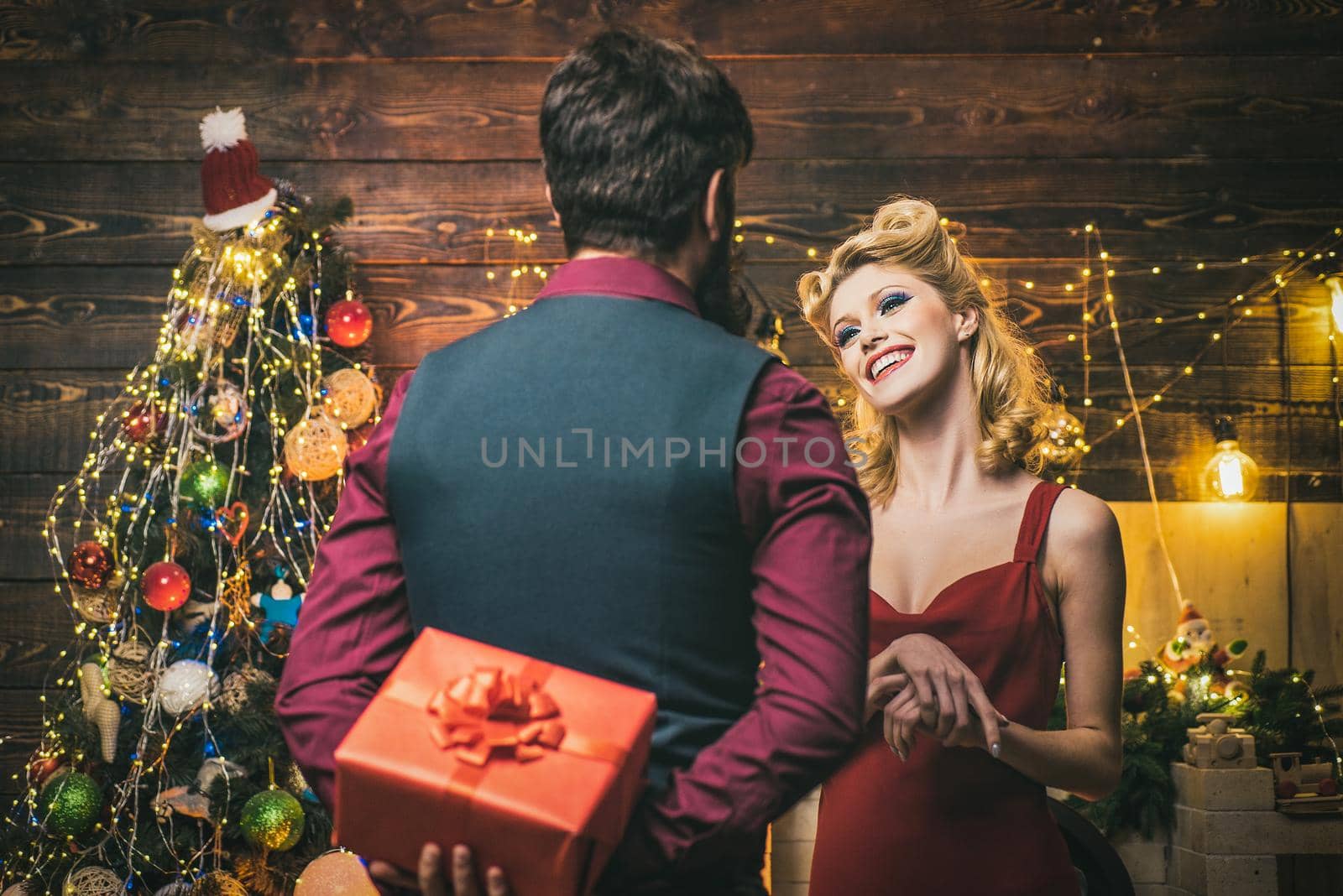 Surprised christmas couple. Family couple celebrating new year or Christmas. Excited and happy emotions. by Tverdokhlib