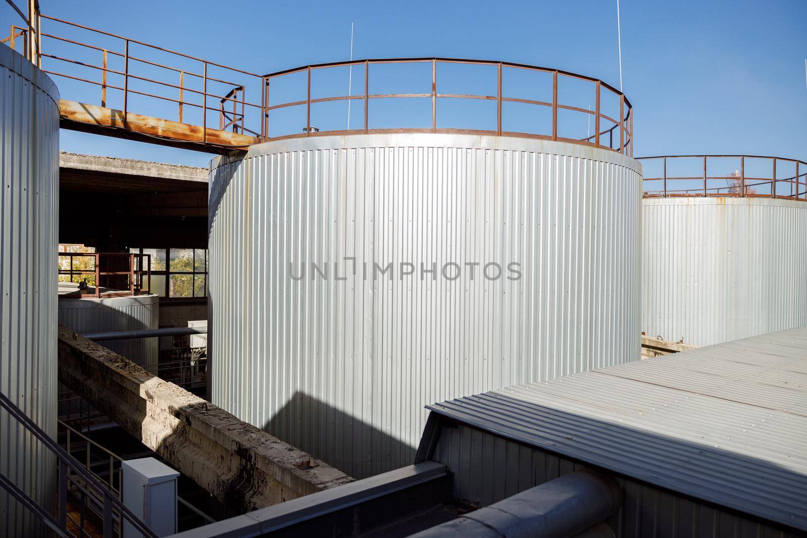 Huge steel storage containers outdoors at factory by Yaroslav_astakhov