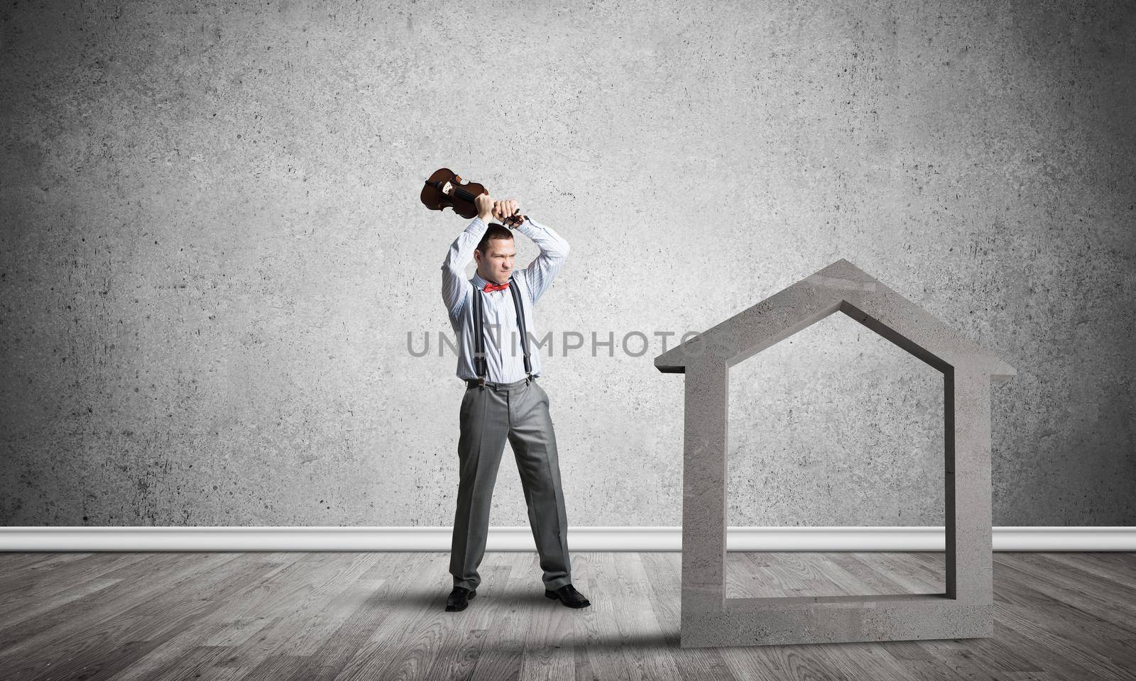 Determined businessman going to break with violin house concrete figure