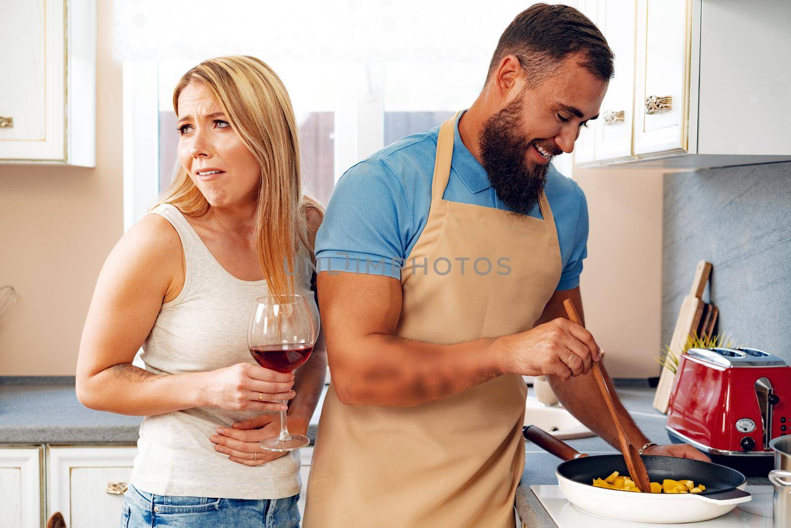 Couple in love preparing meal together in kitchen at home