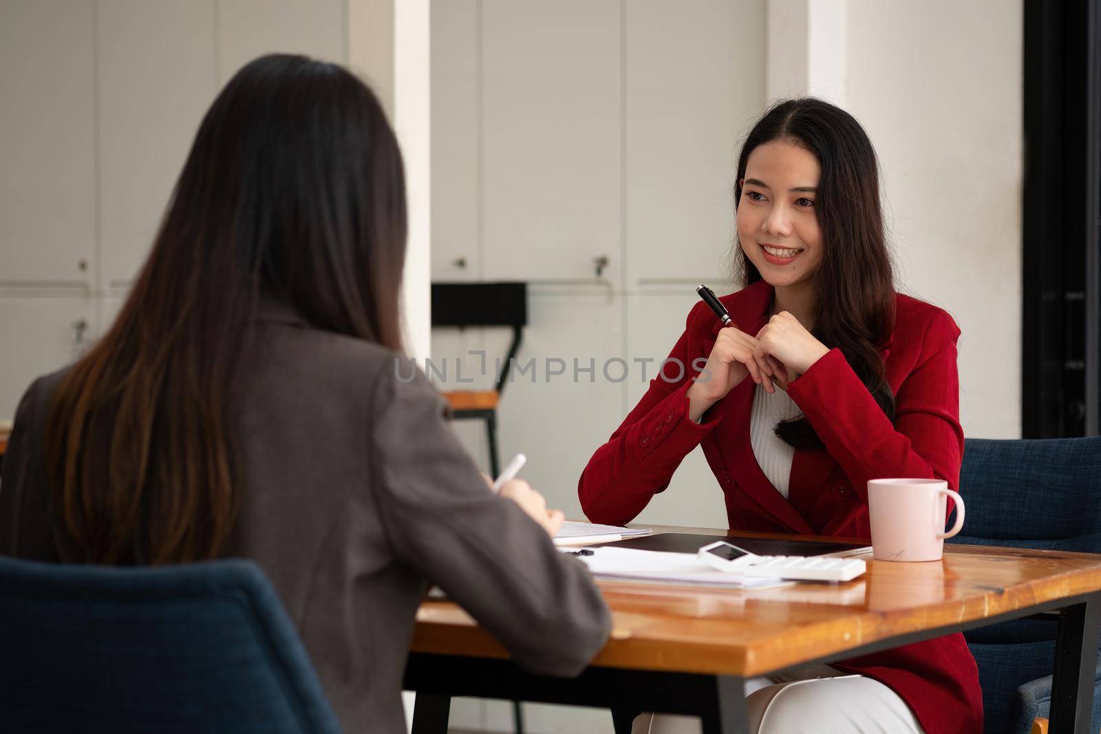 Young Asian businesswoman work together to analysis from work at the office.
