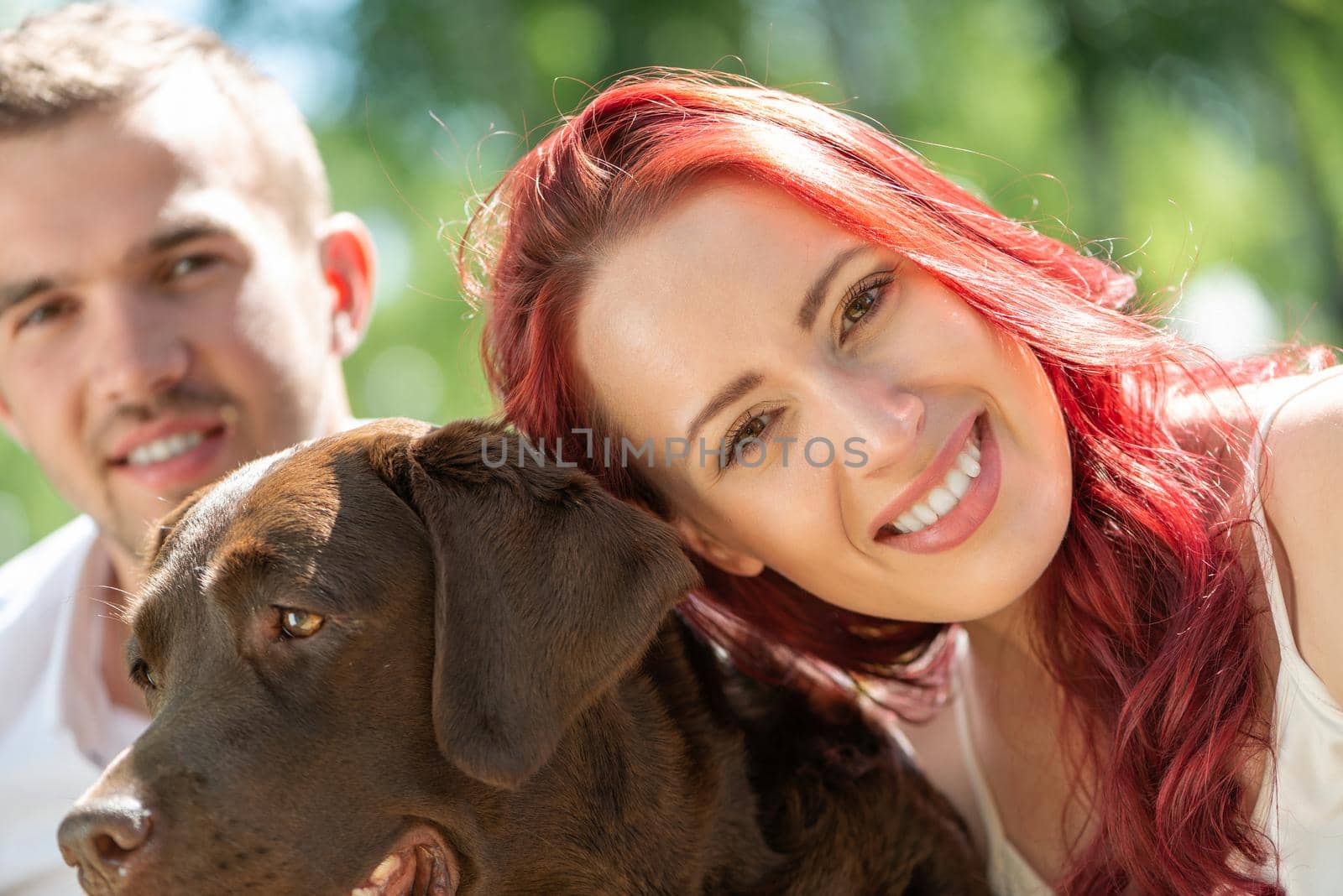 Couple with a dog in the park by adam121