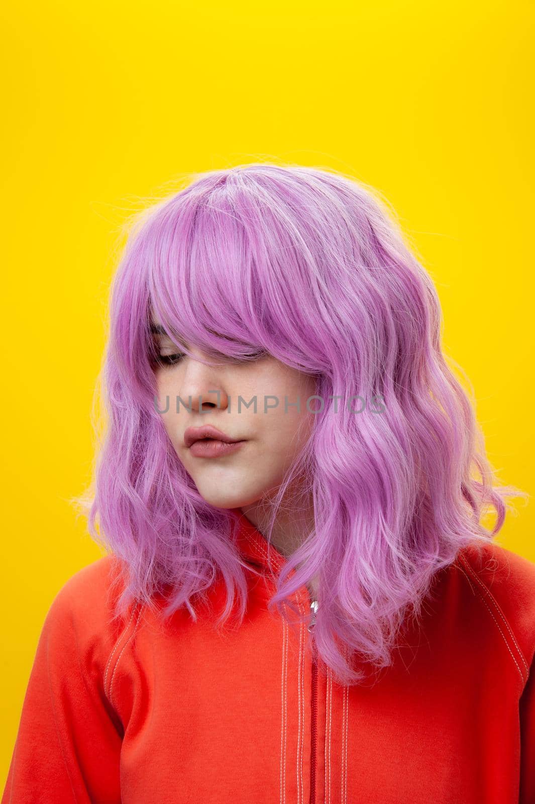 Close up fashion portrait young beautiful woman with pink hair on yellow background. Copy space.