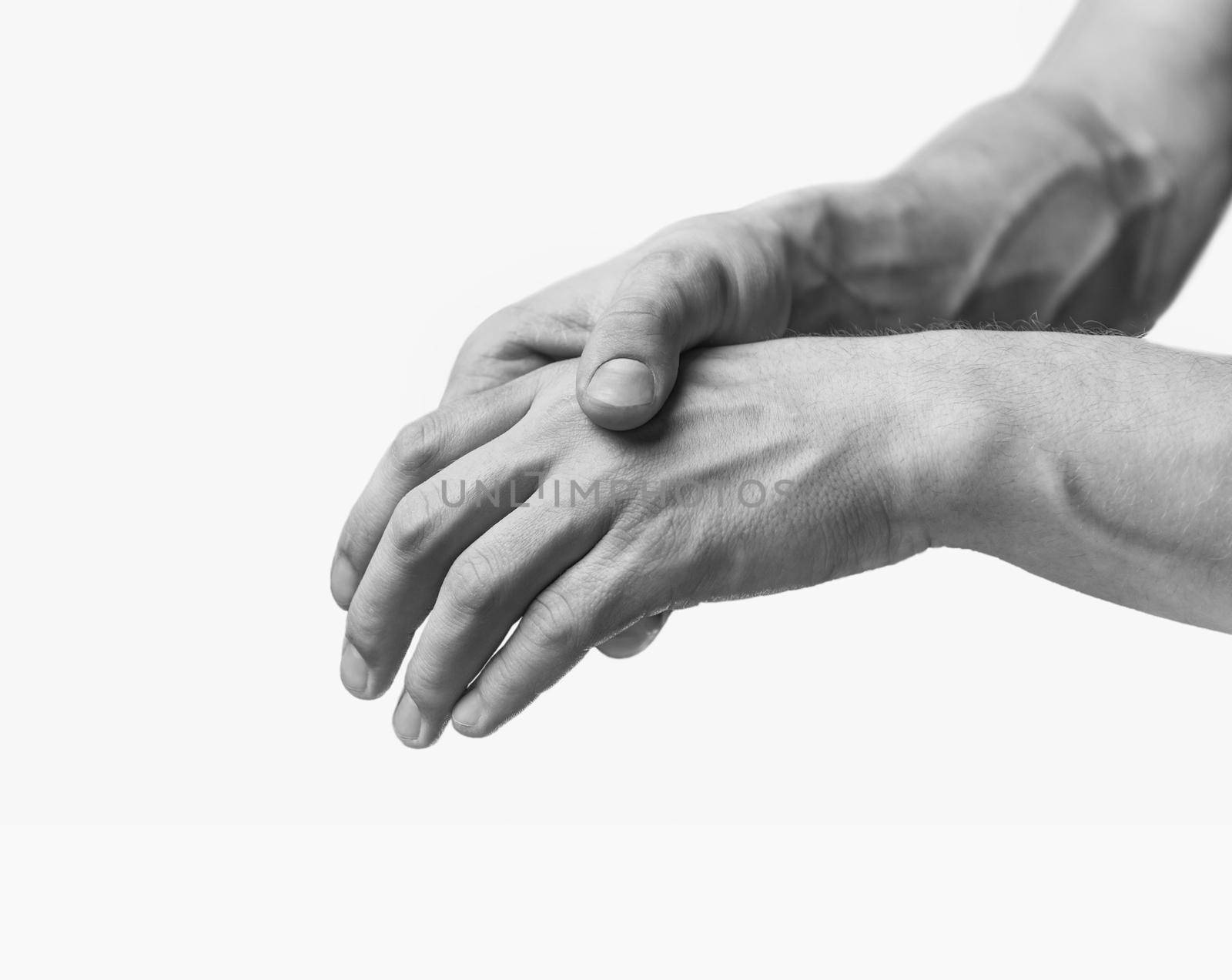 Pain in a male hand. Man holds his hand. Monochrome image, isolated on a white background