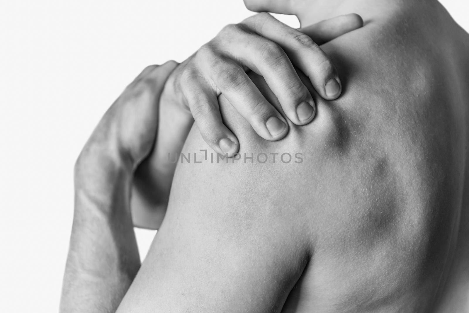 Man compresses his shoulder, pain in the shoulder. Monochrome image, isolated on a white background
