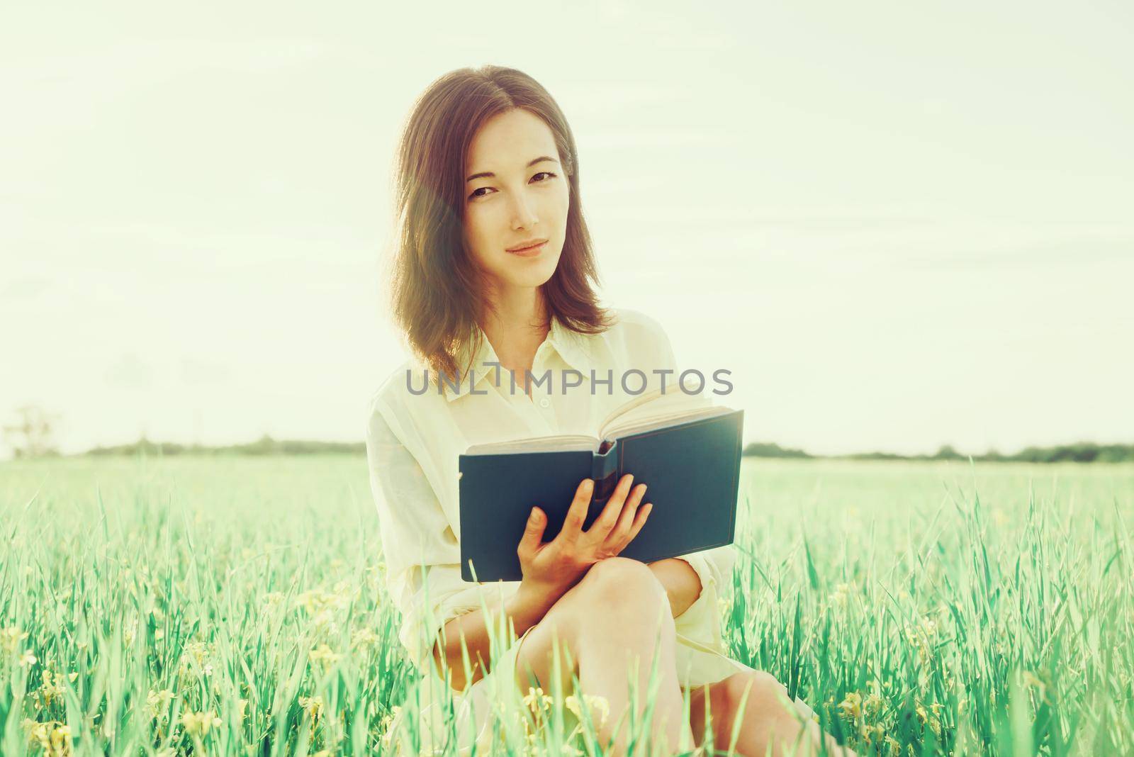 Girl with book outdoor by alexAleksei