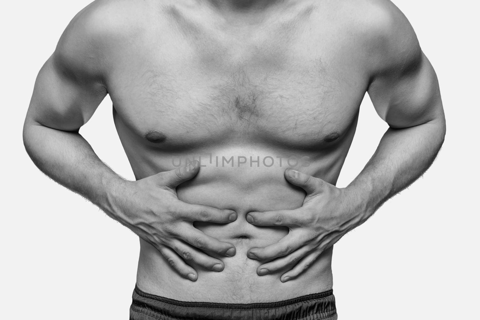 Unrecognizable man compresses the abdomen due to pain. Monochrome image, isolated on a white background