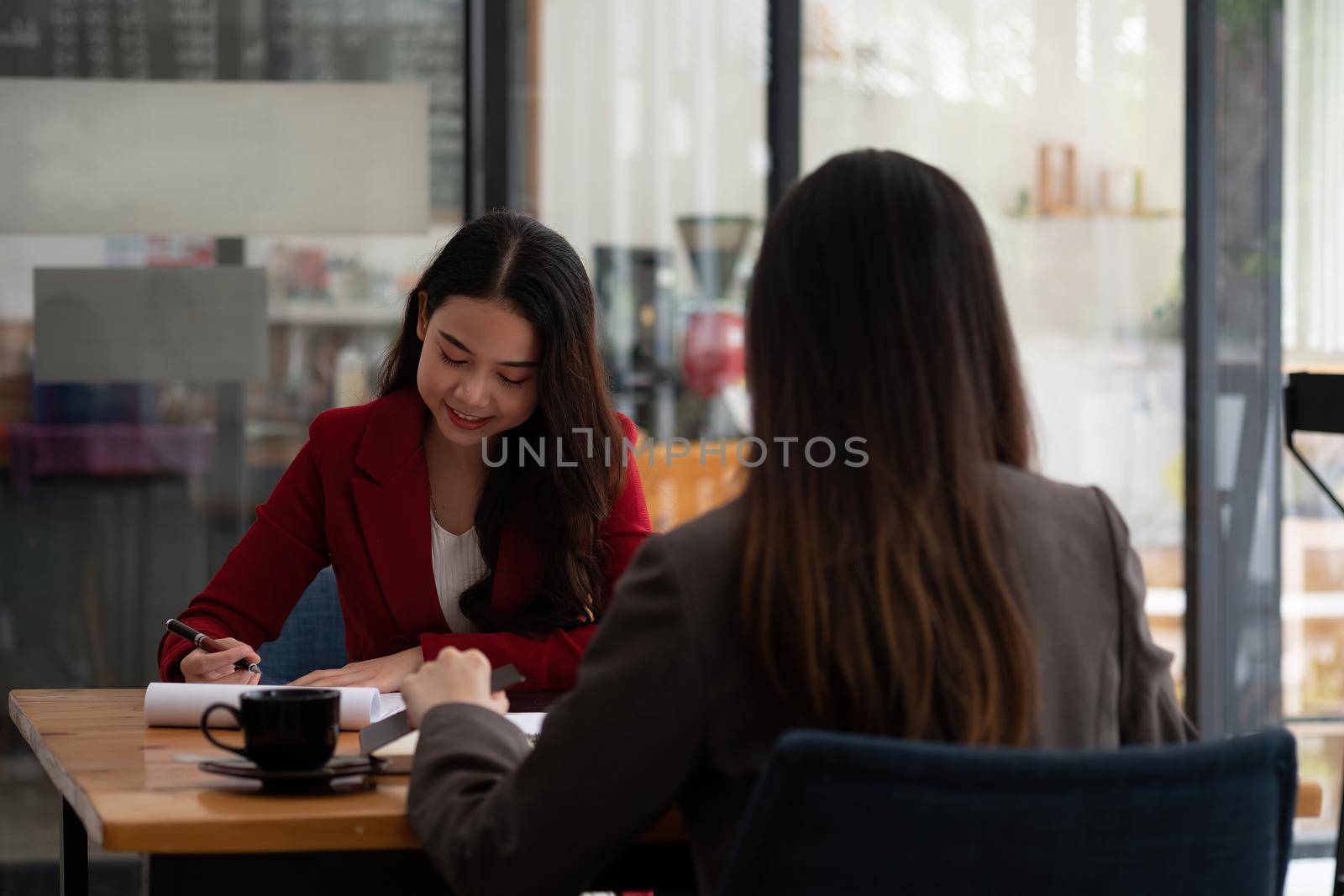 Young Asian businesswoman work together to analysis from work at the office.