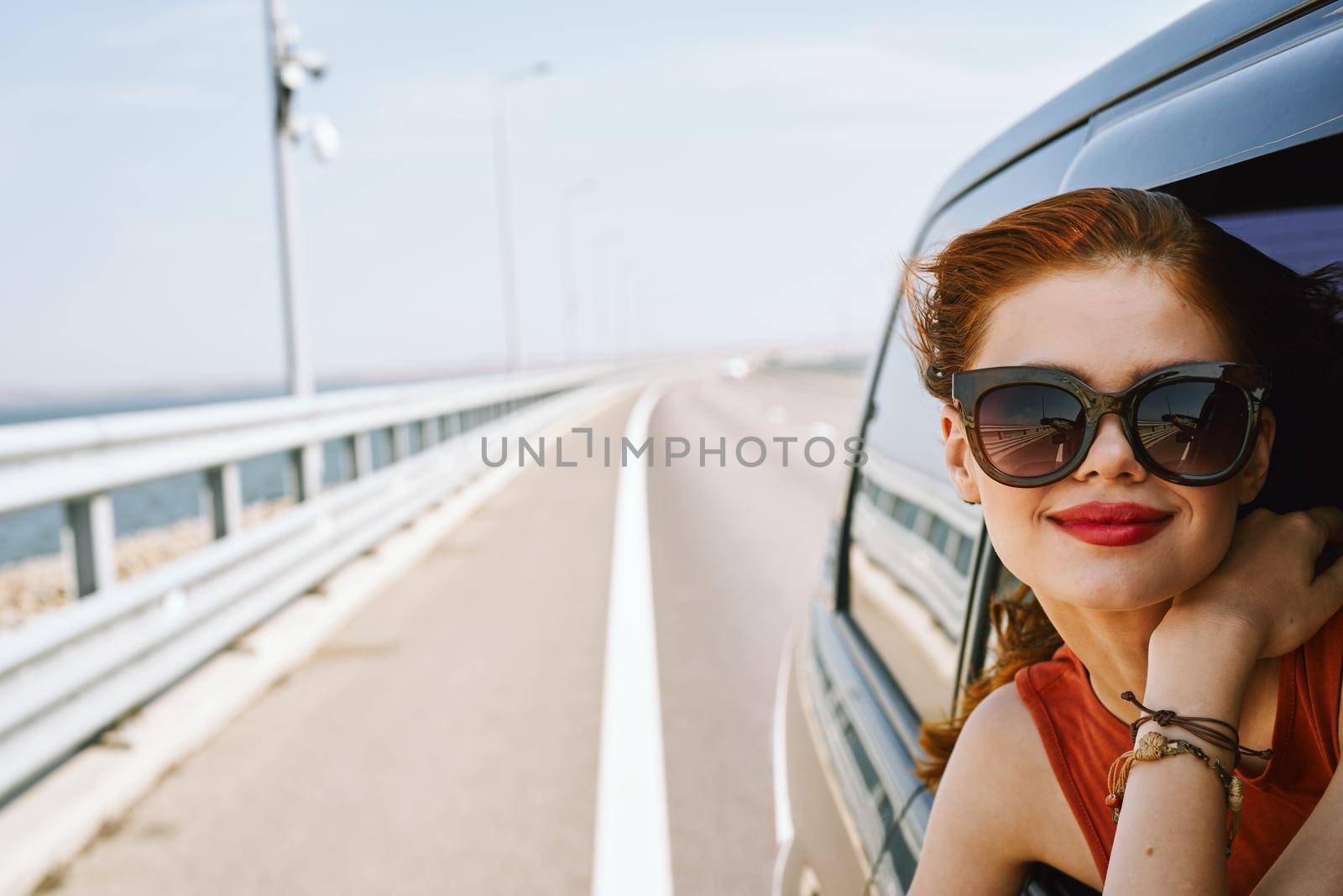 pretty woman in sunglasses rides in a travel car by Vichizh