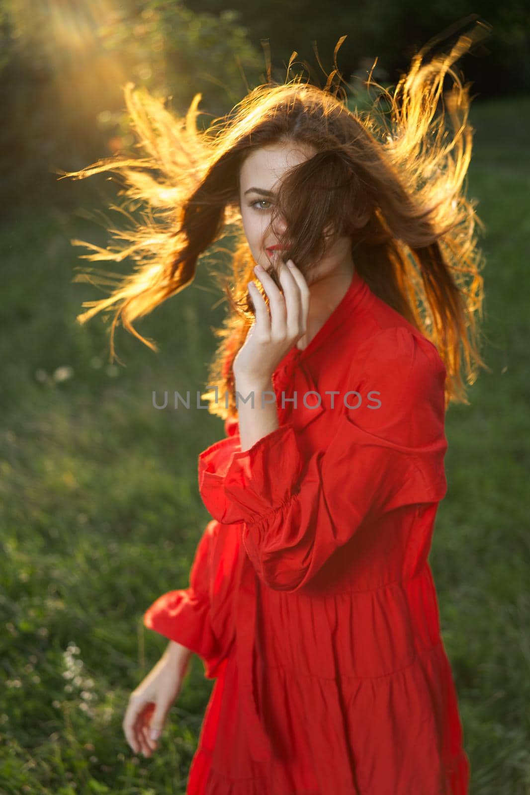 woman in red dress posing nature sun fun. High quality photo