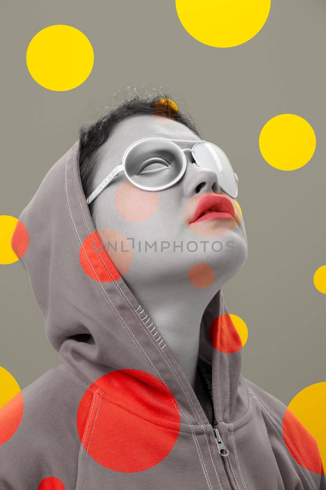 Art collage with alternative funky girl. Close up fashion portrait young beautiful woman in hoodie and white strange glasses with eye. Multi-colored circles. Unusual youth fashion concept. by bashta