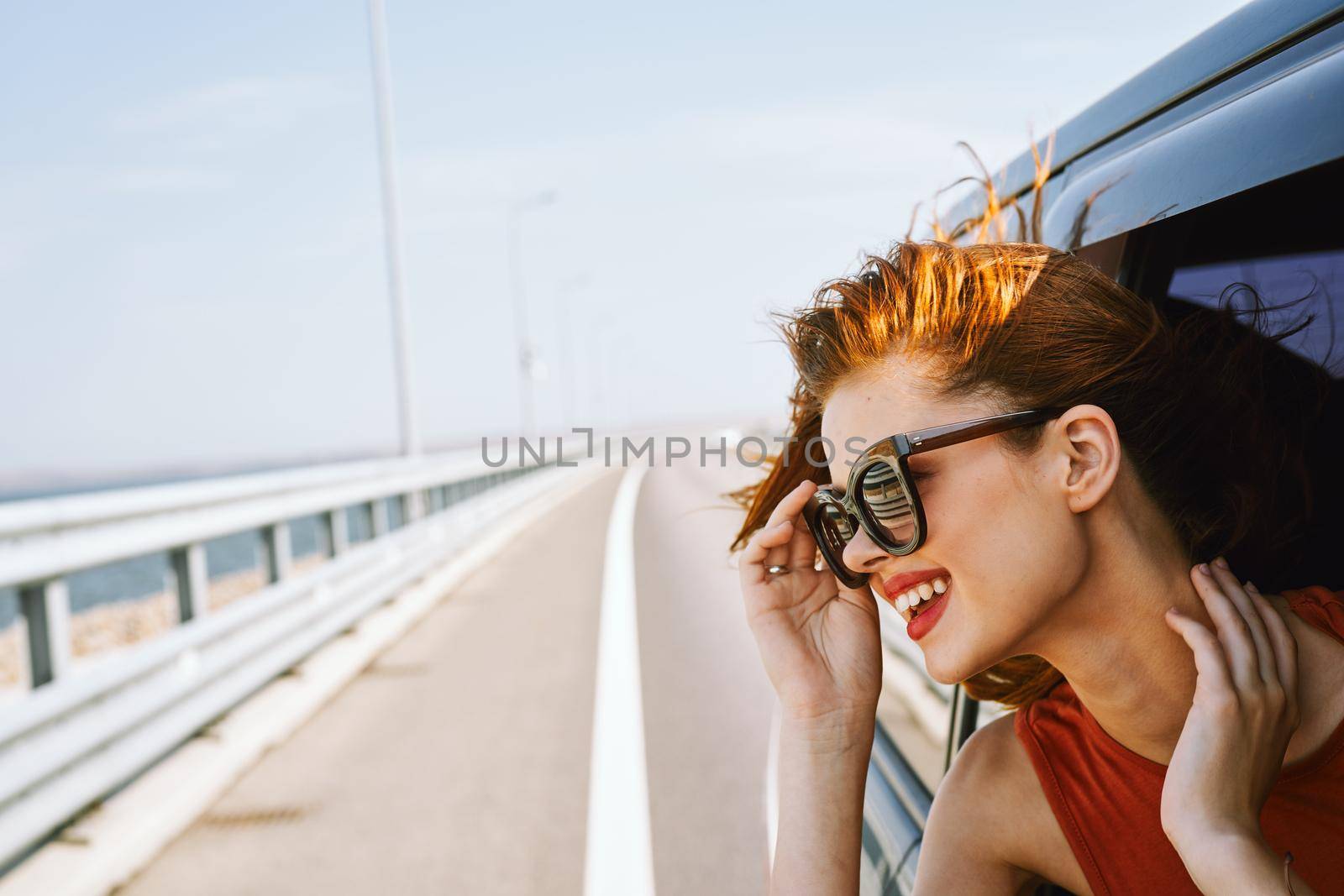 pretty woman in sunglasses rides in a travel car by Vichizh