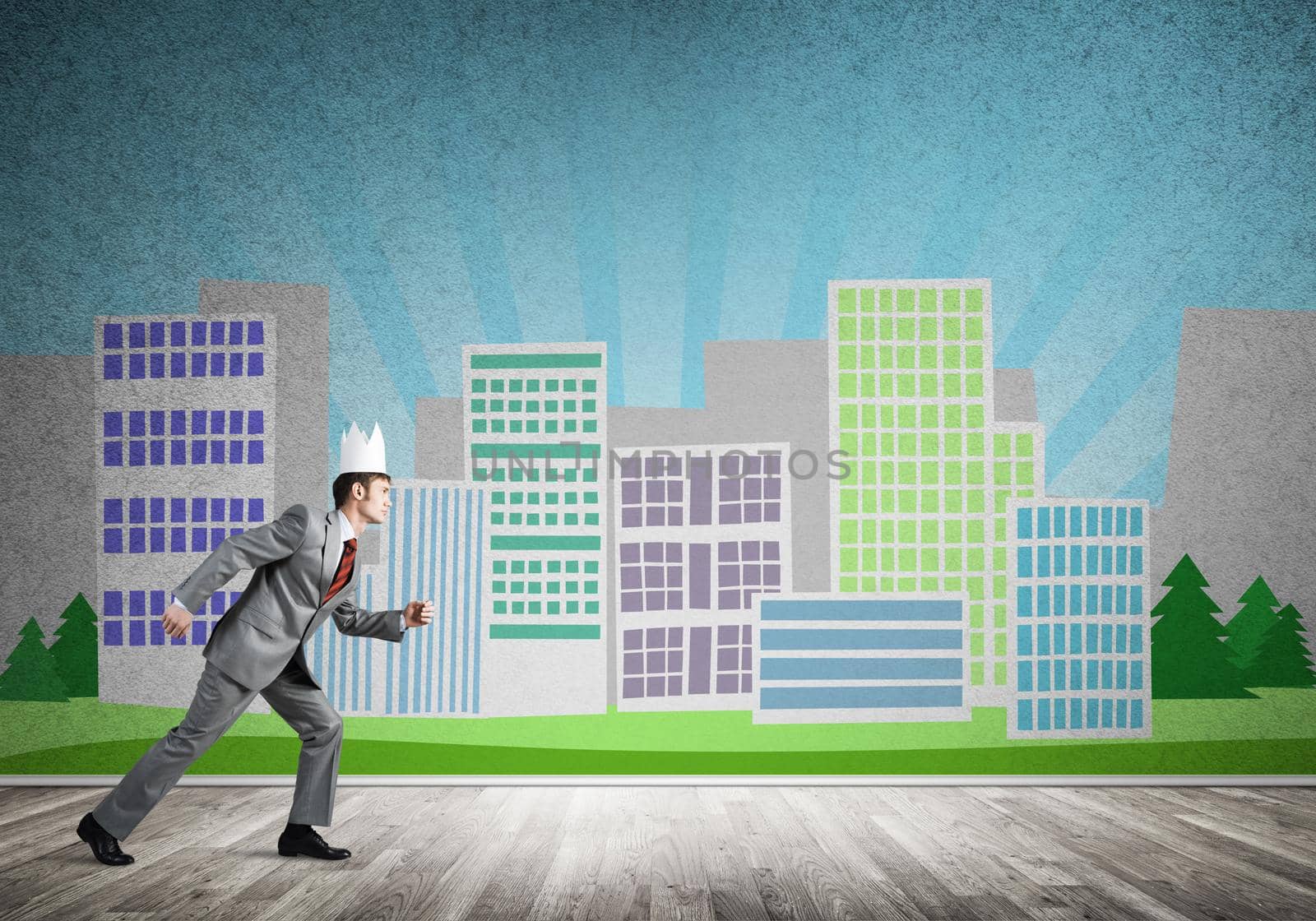 Young handsome businessman wearing white paper crown running in a hurry