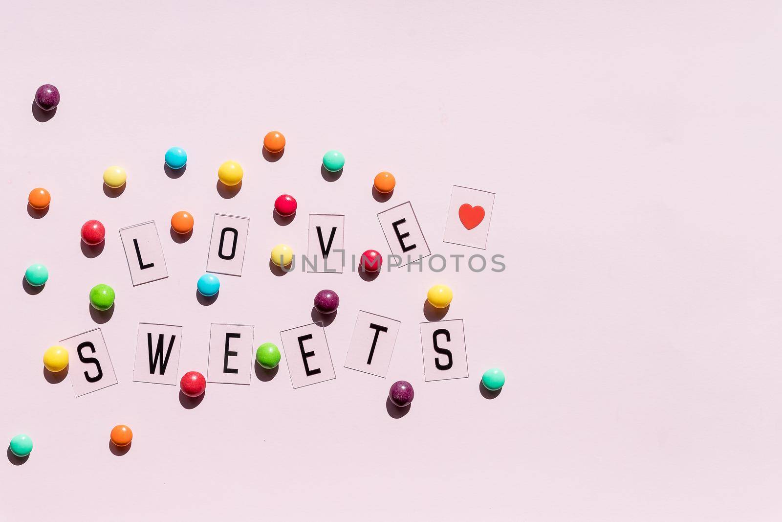 Assortment of sweet candies on color background