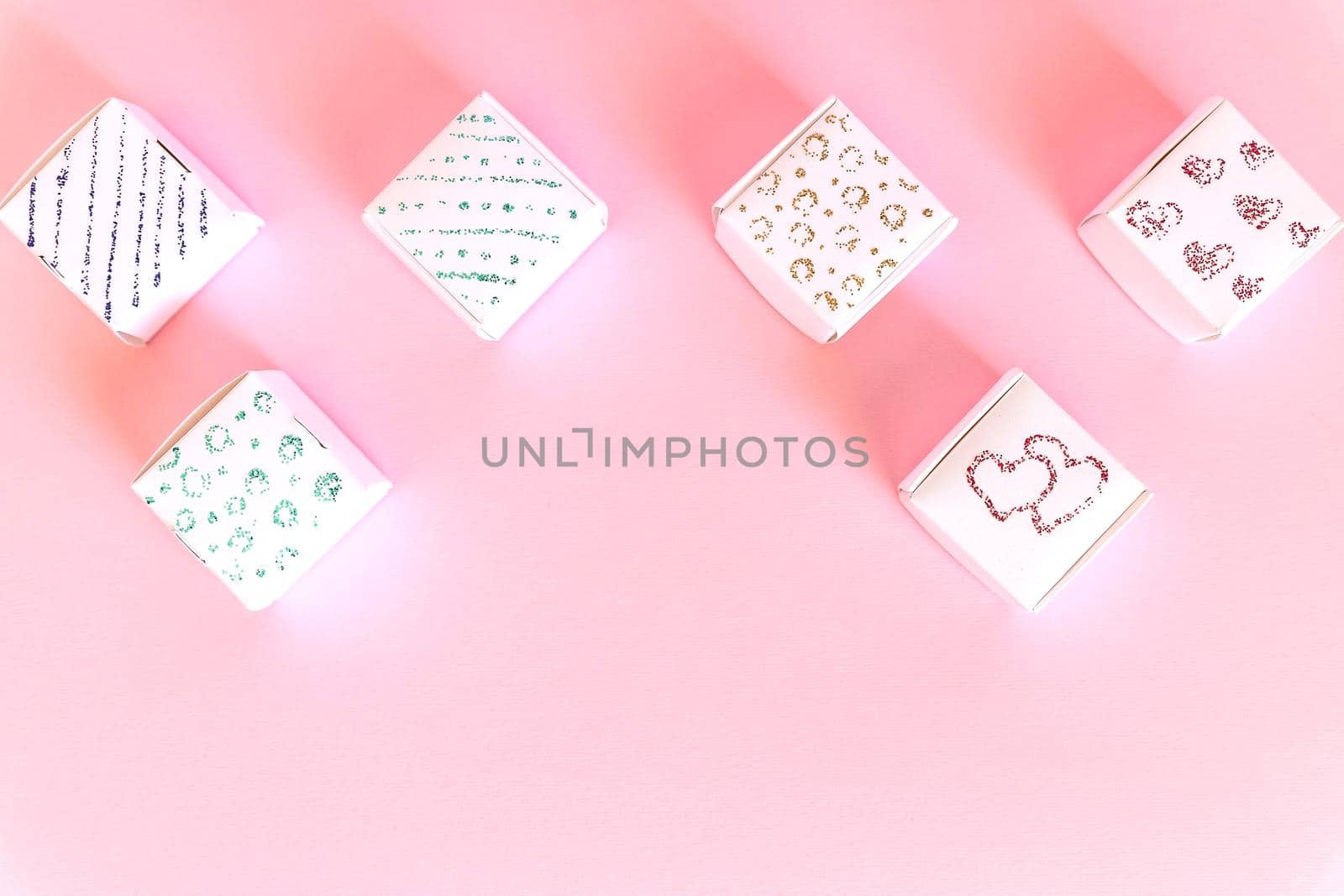 Composition of holiday white gift boxes with red hearts on colorful background.