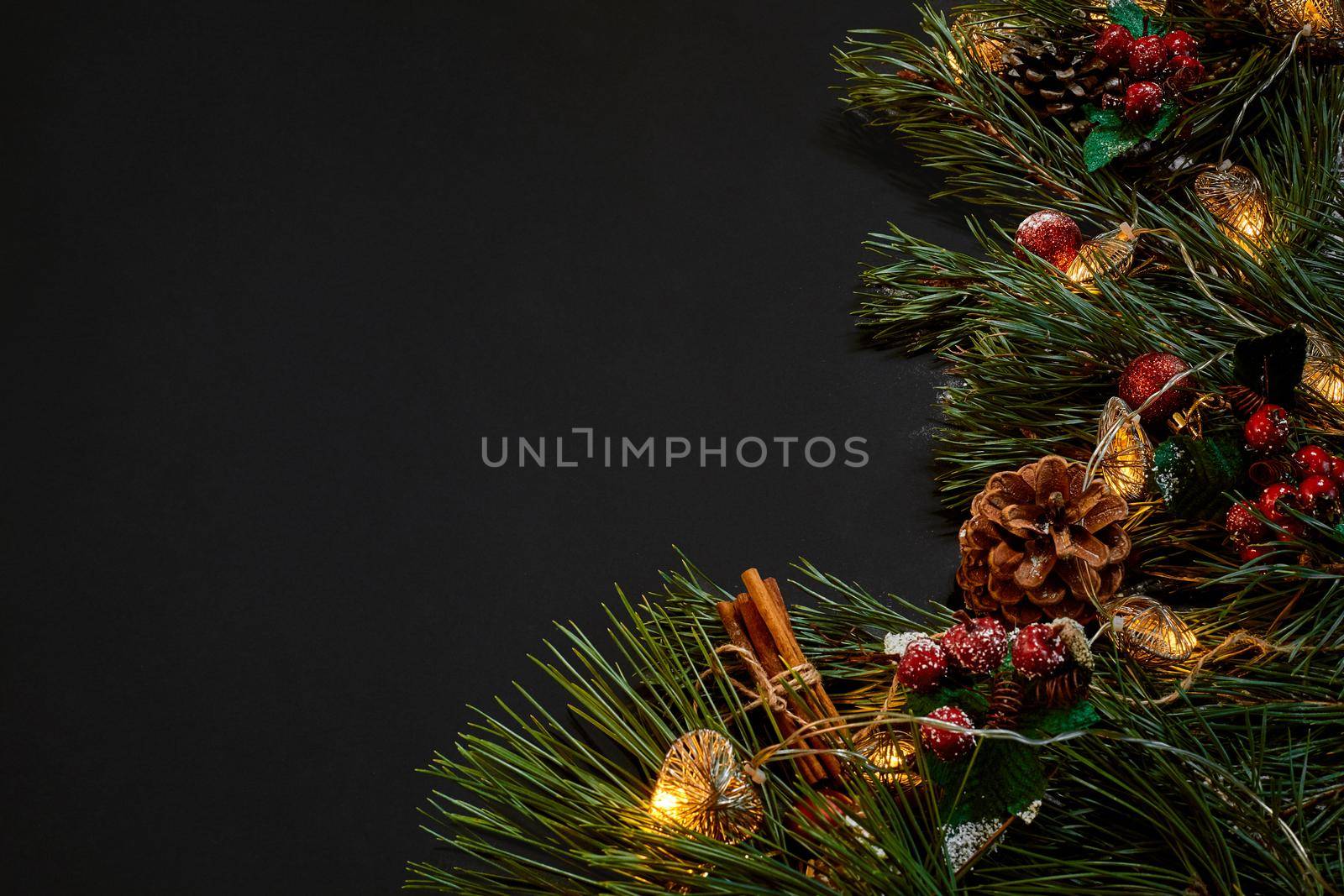 Christmas. Xmas toys and spruce branch on black background top view. Copy space. Still life. Flat lay. New year