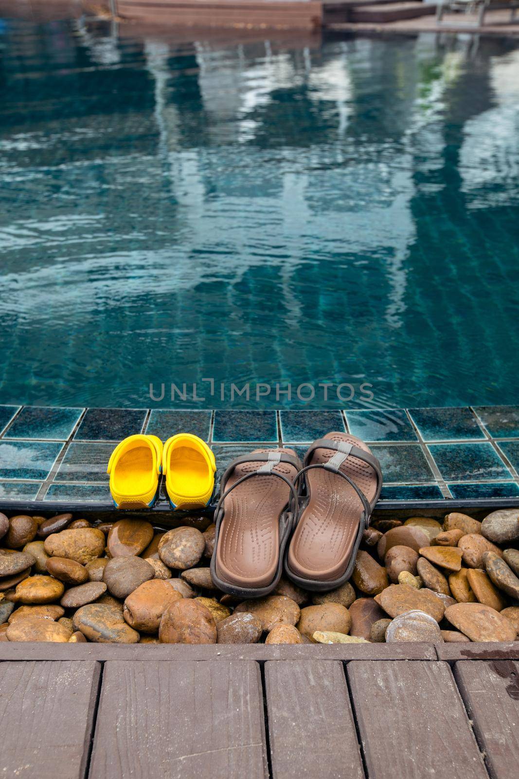 Slippers on edge of pool by Demkat