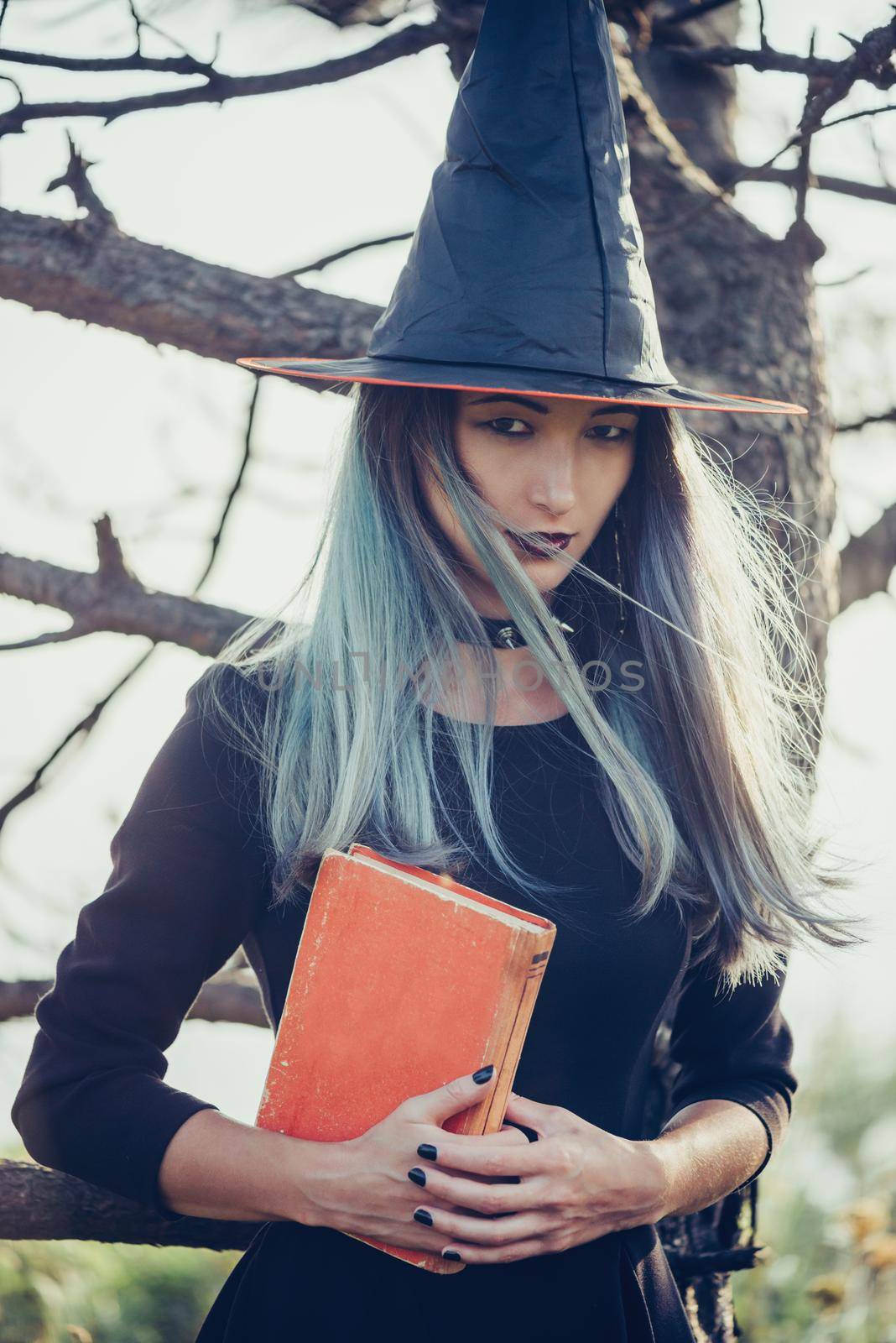 Young witch with book by alexAleksei