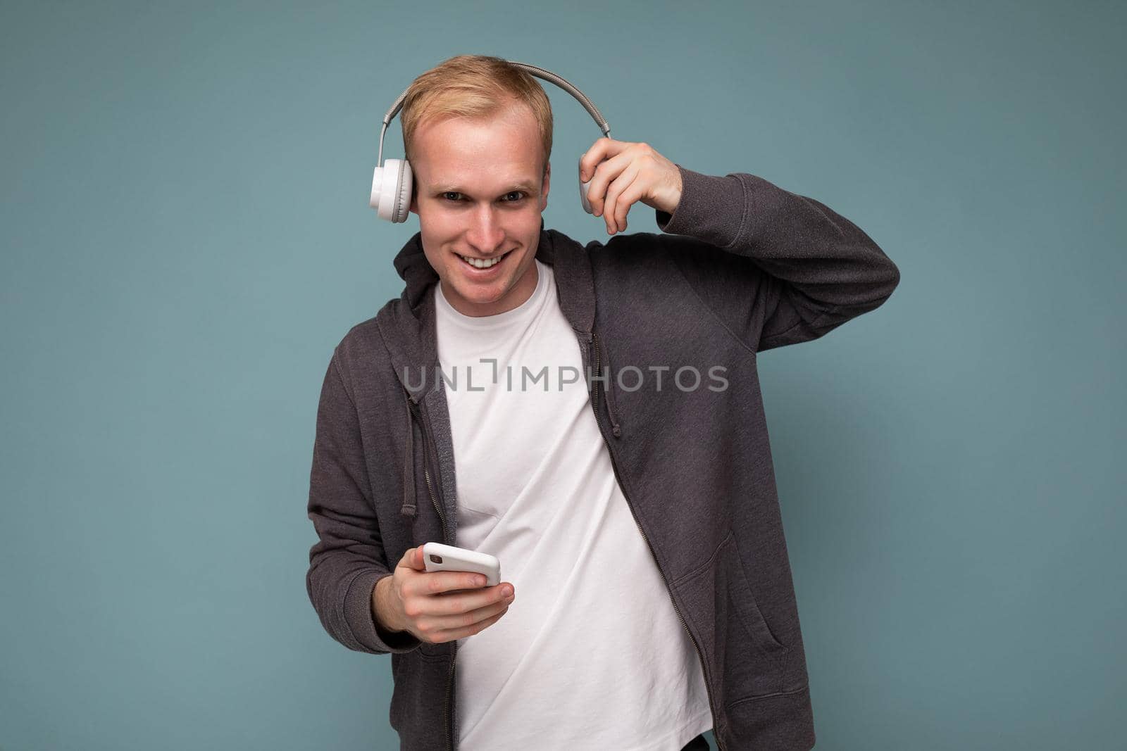 young man wearing casual white t-shirt isolated over blue background.